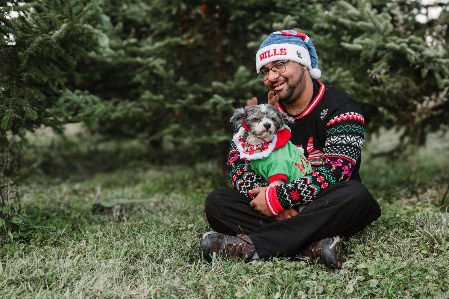 Holiday photos with dog wearing festive Christmas sweaters and Santa hats.