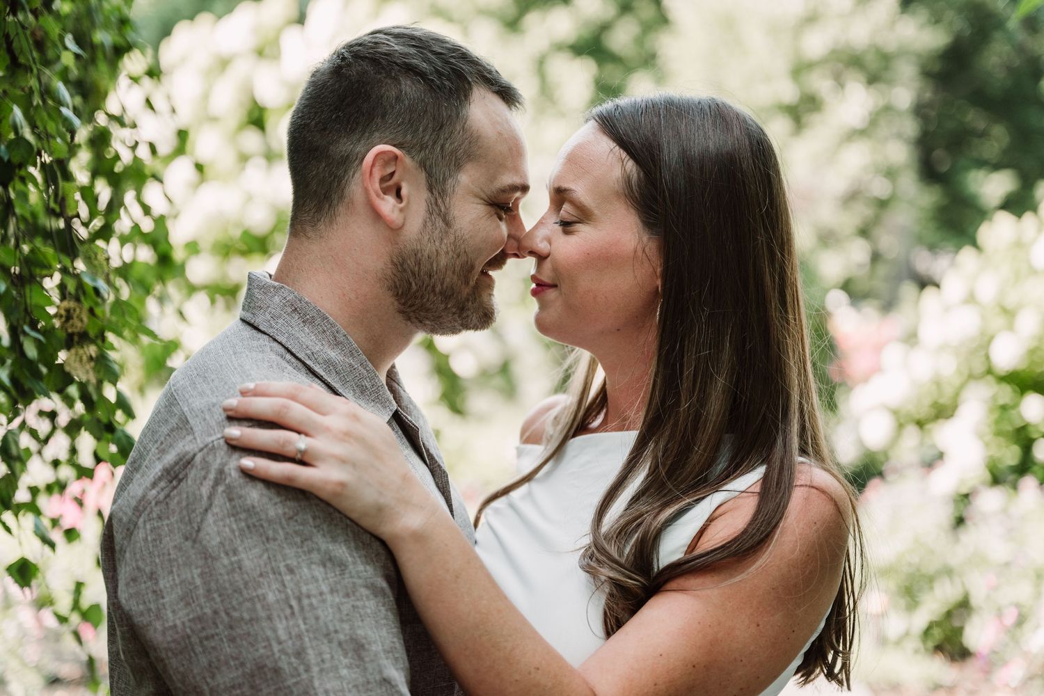Tender moment captured during an outdoor engagement photoshoot.