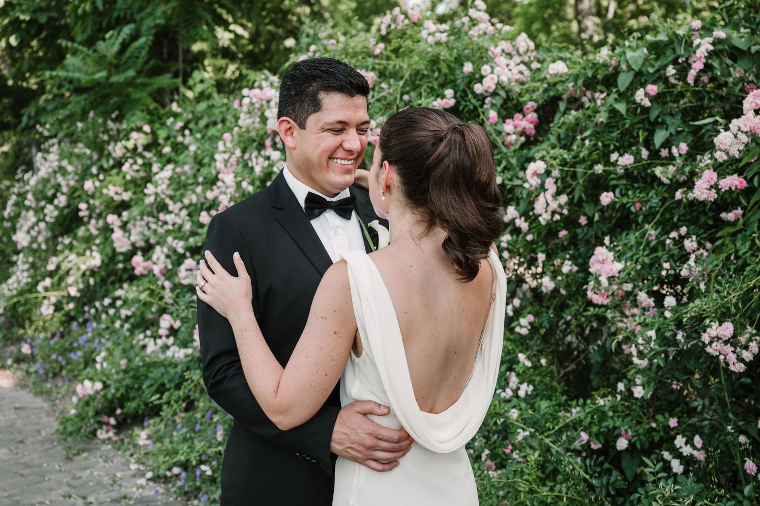 A romantic wedding photo sequence in a garden with pink climbing roses.