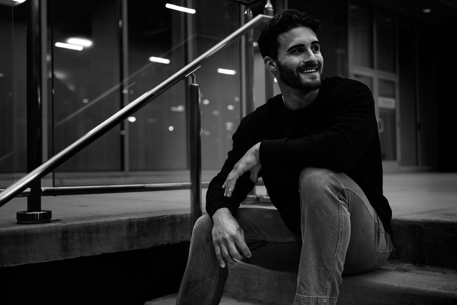 A sequence of moody black and white photographs showing a person walking in an urban setting.