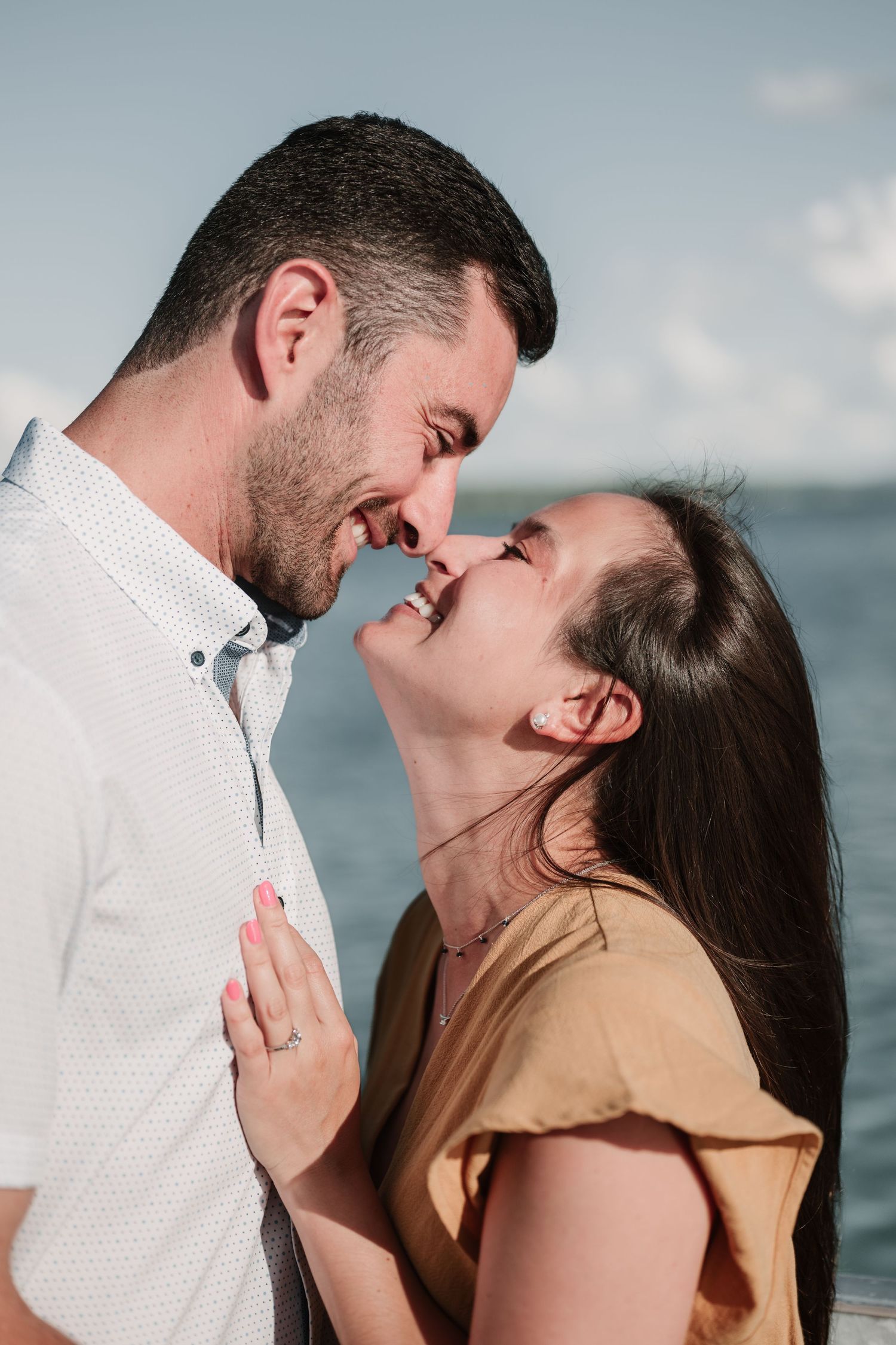 An intimate seaside proposal moment captured in close-up frames.