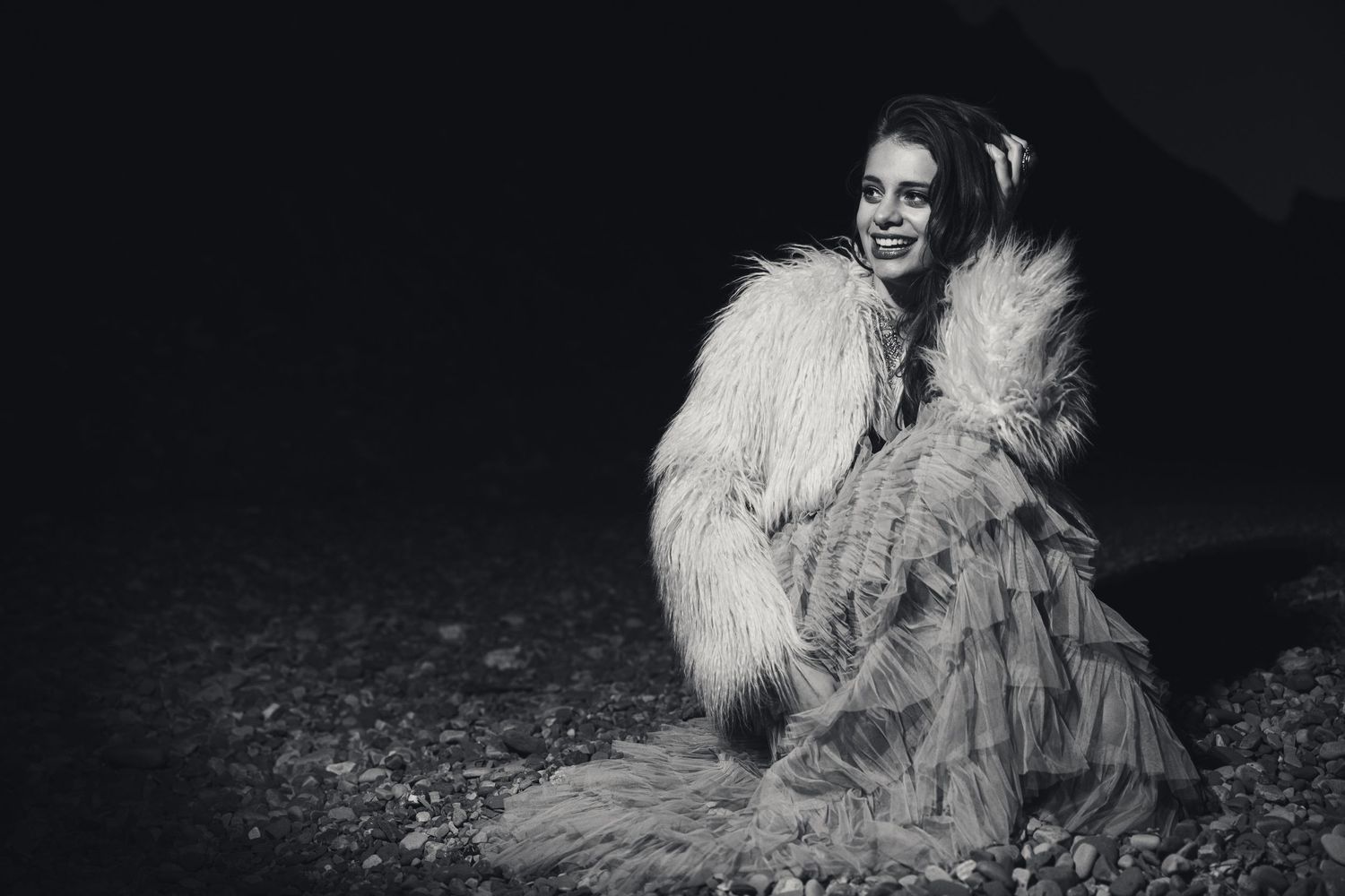 A series of high contrast black and white artistic portraits with dramatic lighting and shadows.