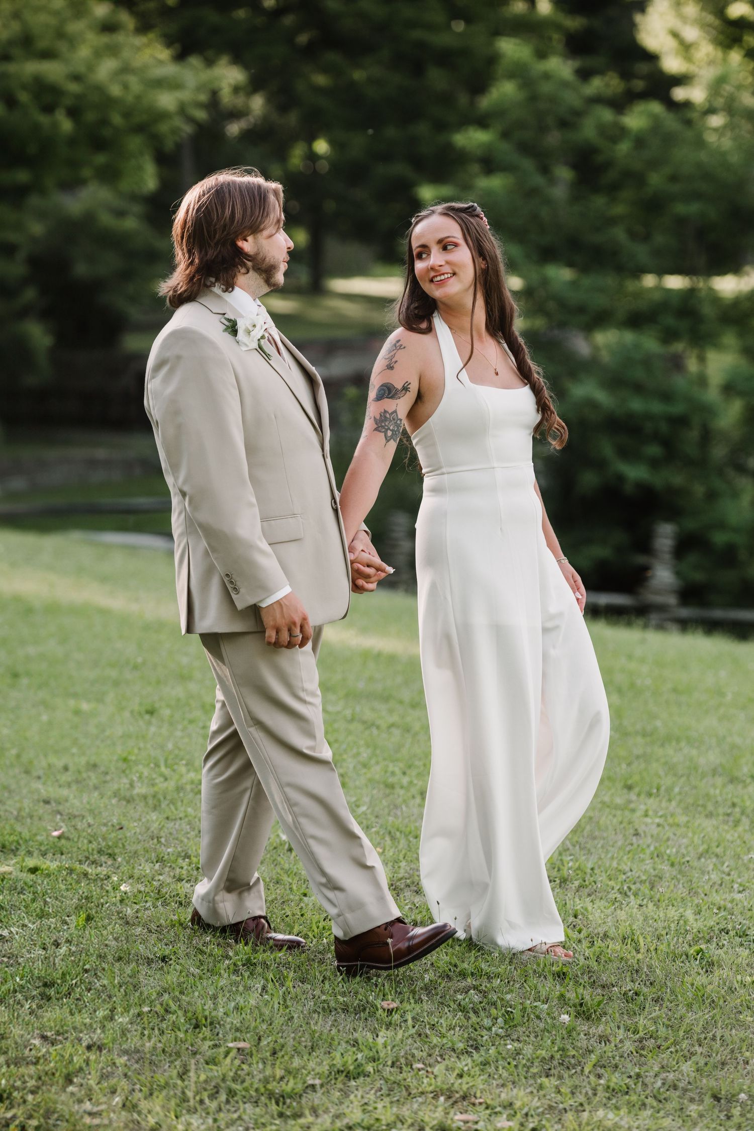 Candid wedding moments captured on a grassy lawn in summer.