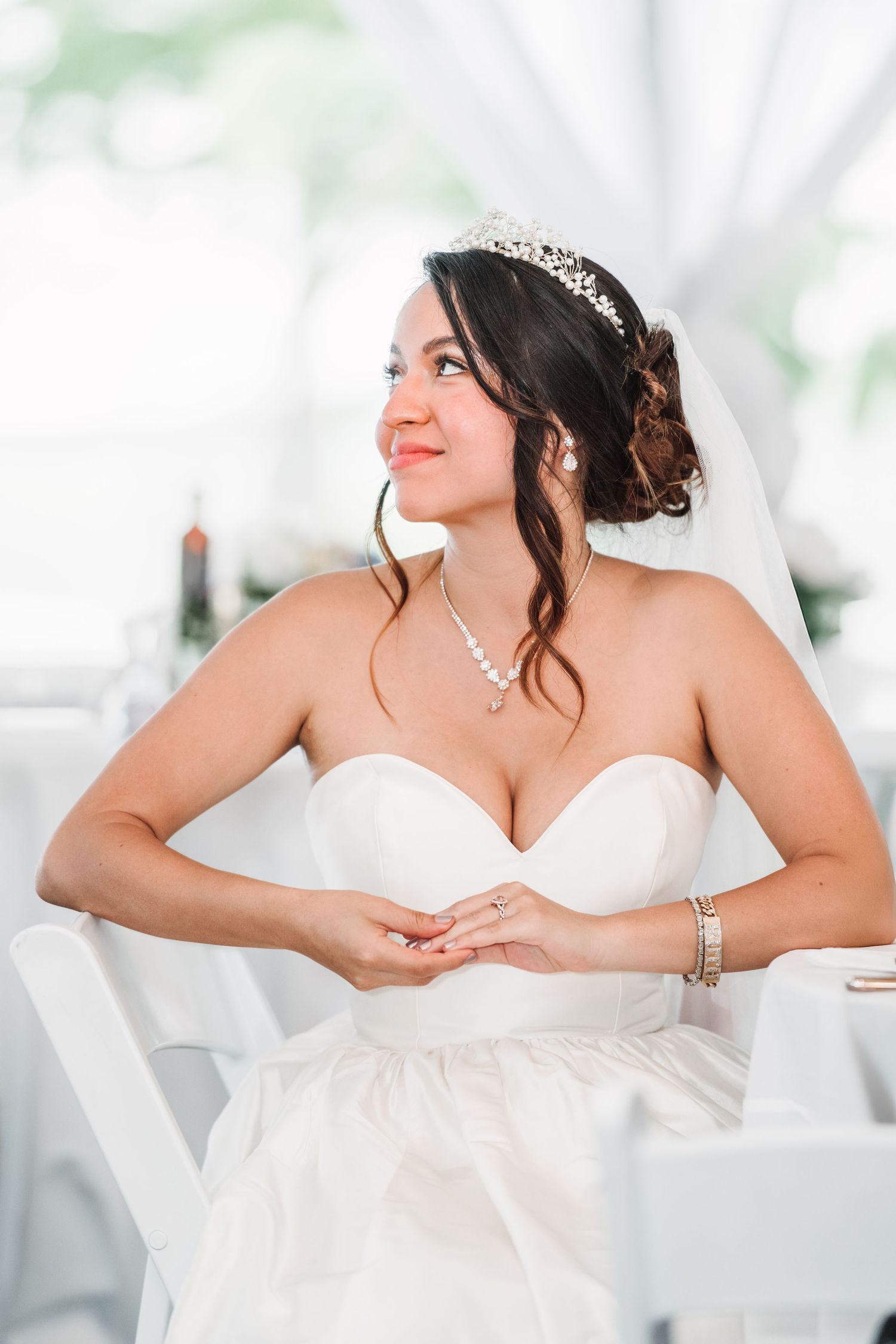 Elegant bridal portraits in white dress with delicate details and tiara.