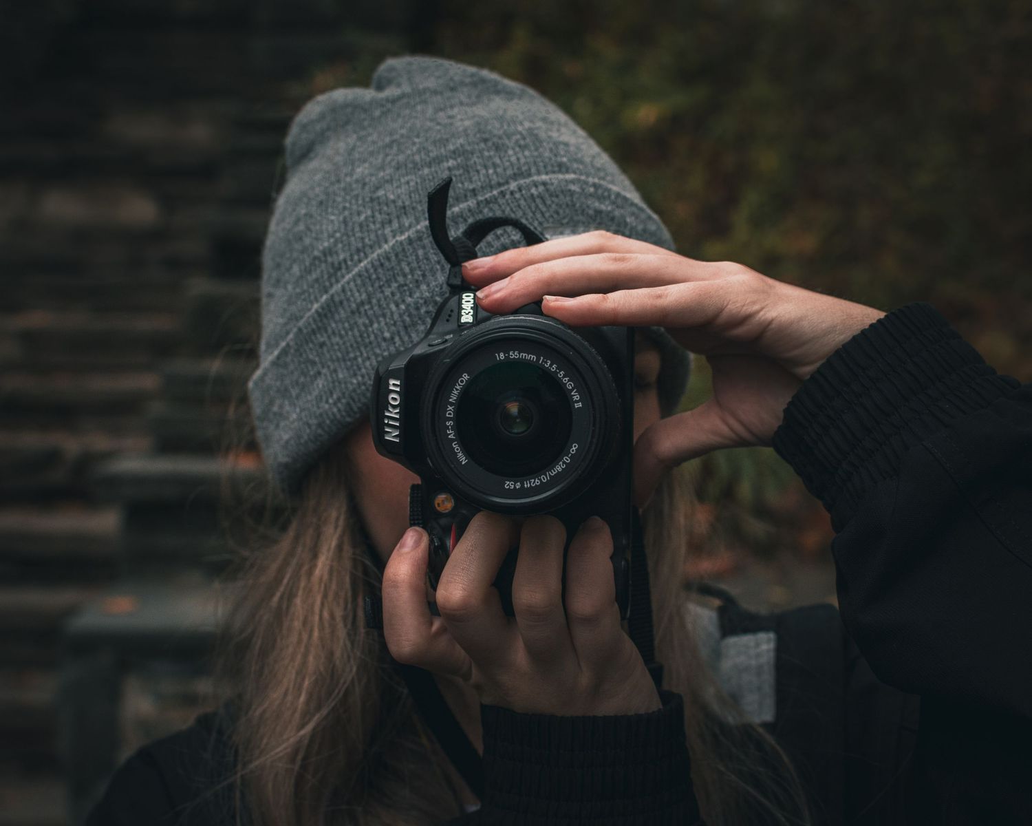 Sequence showing a photographer wearing winter gear while taking pictures outdoors.