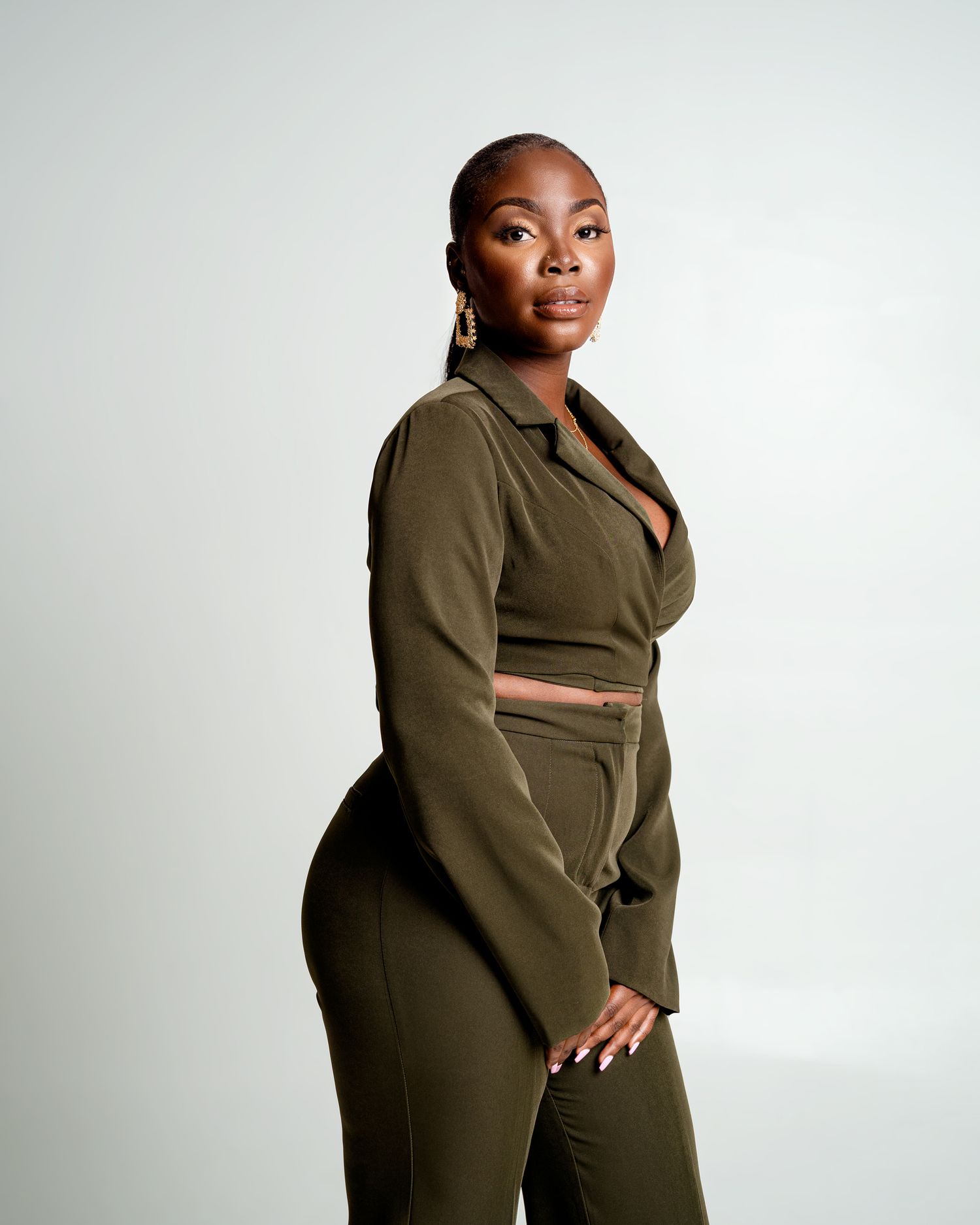 Model in olive green two-piece outfit poses against white backdrop showing different angles and poses.