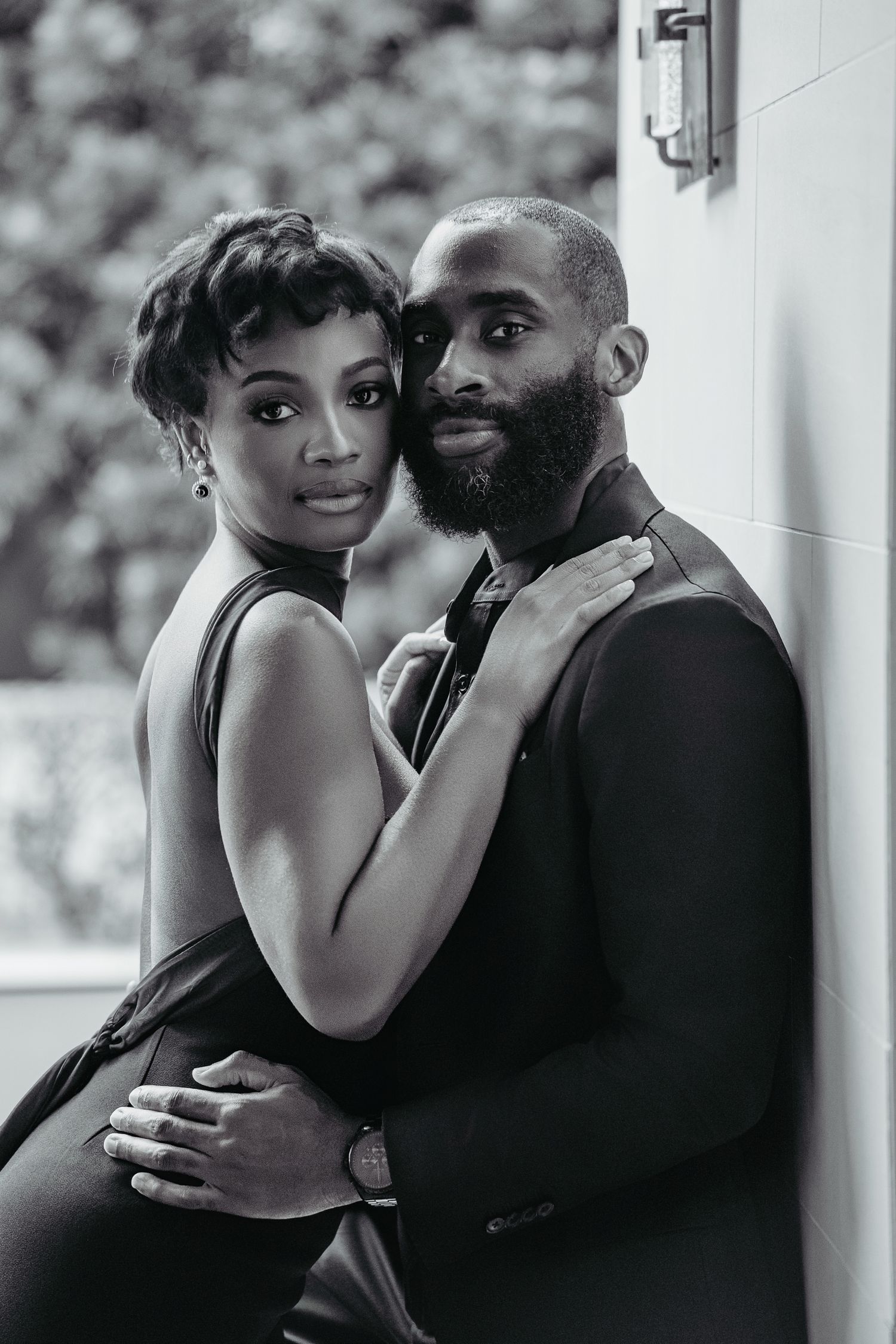 Intimate black and white engagement photos showing a romantic couple embrace.