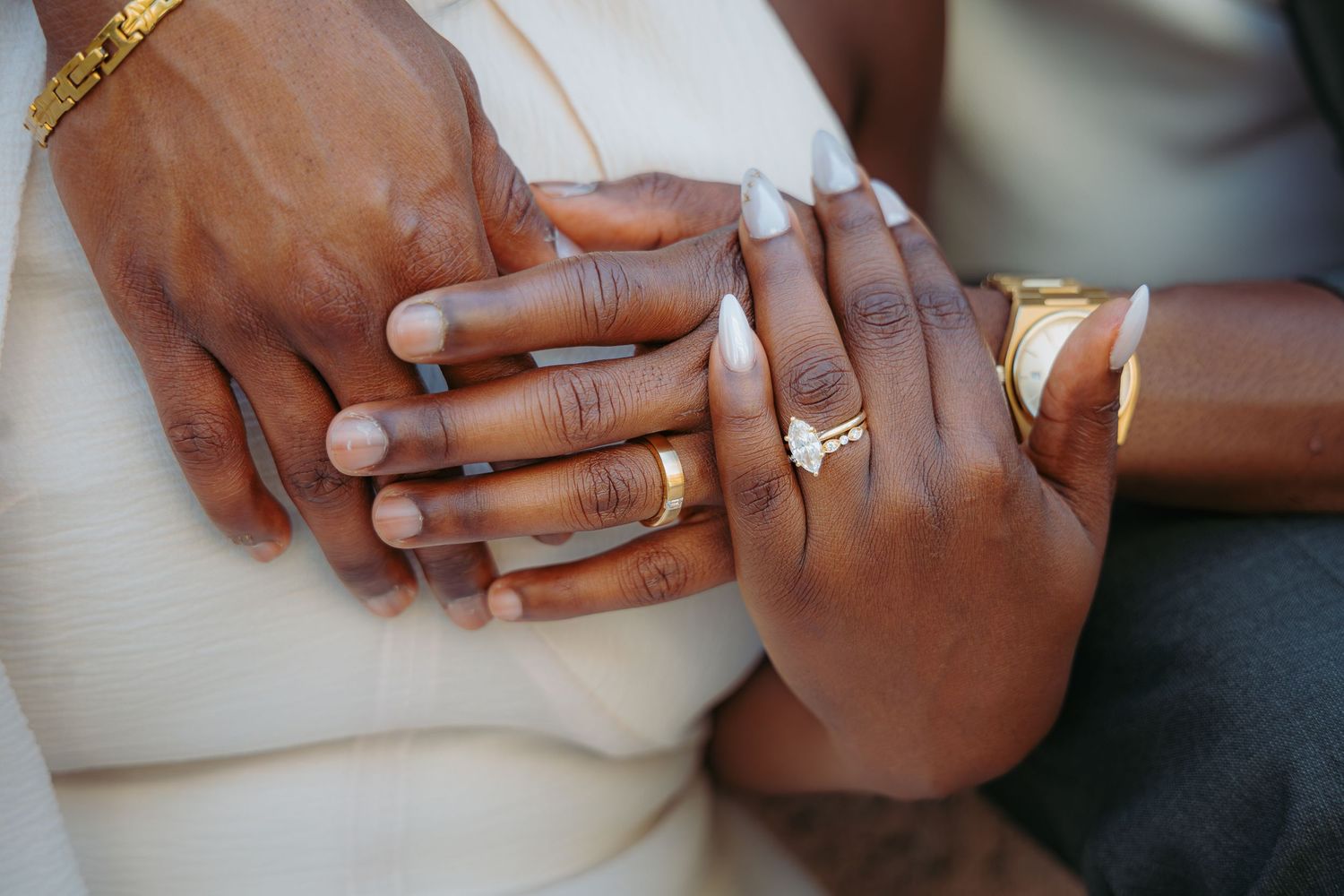 Close-up view of hands showing engagement rings and wedding bands in a series of romantic poses.
