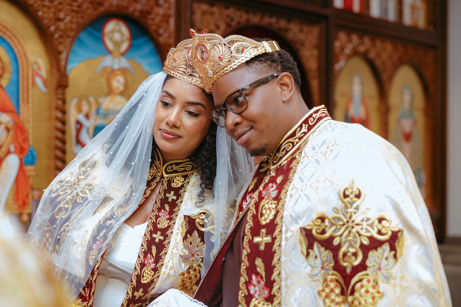 Orthodox Christian wedding ceremony with ornate gold crowns and traditional ceremonial attire.