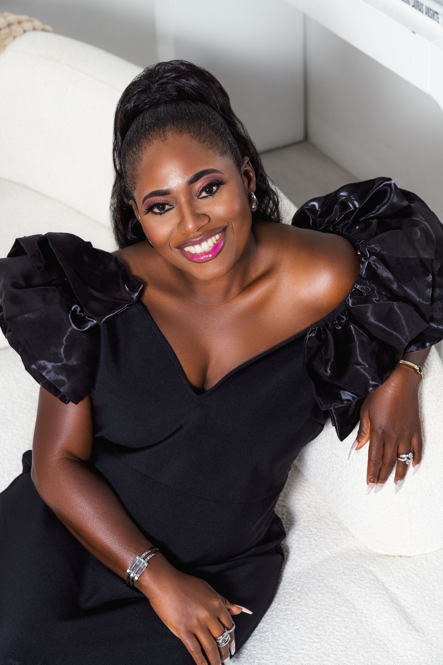 A series of glamour portraits showing a woman in a black ruffled dress posing elegantly against a white background.
