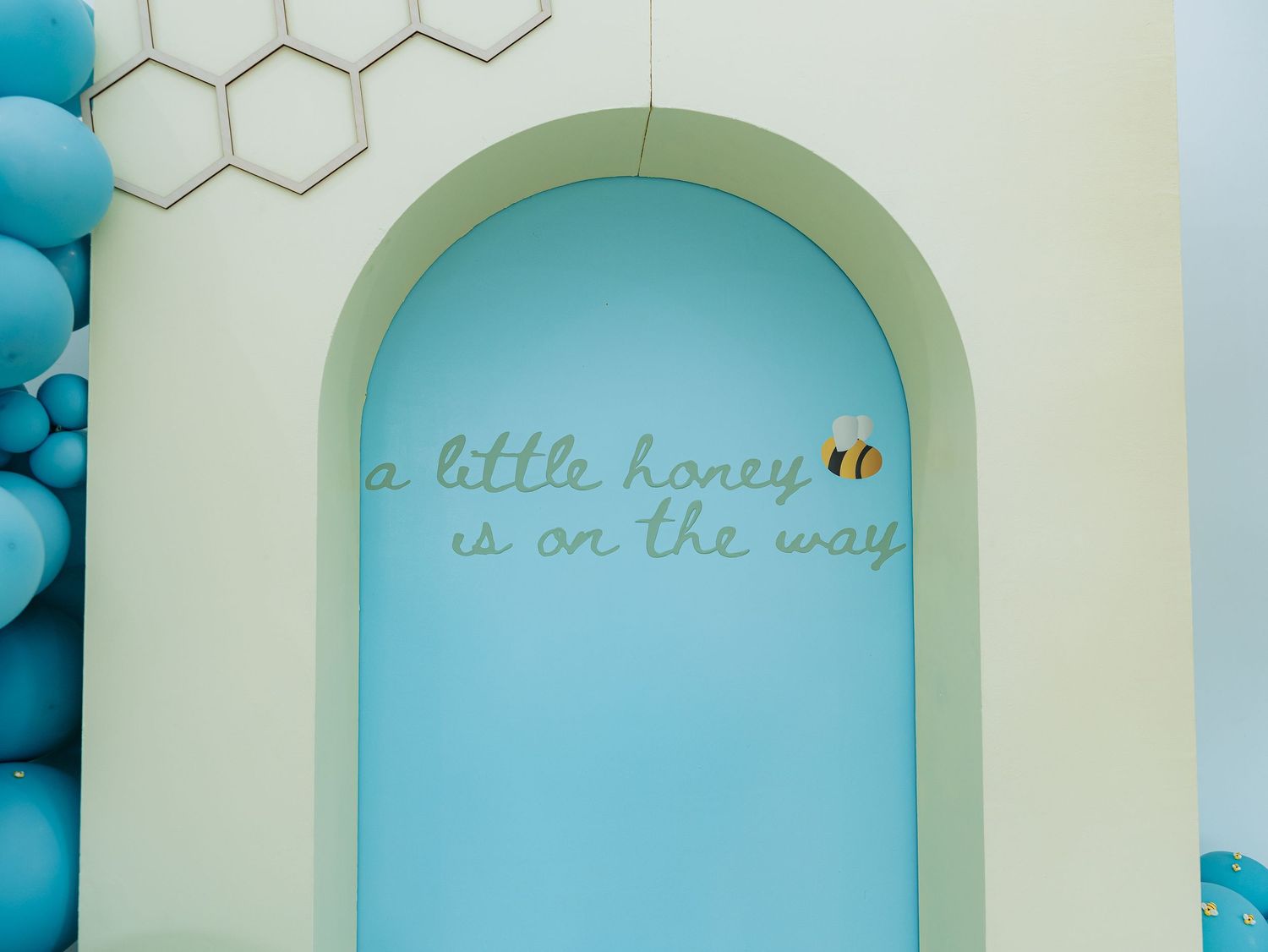 A decorative arched doorway or window frame painted in mint green against a light blue wall.