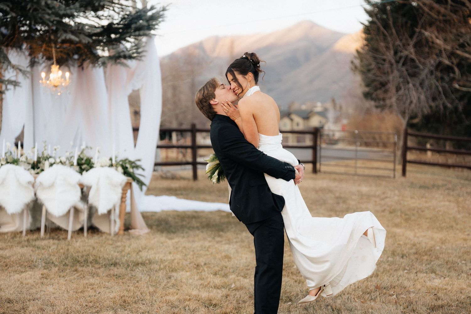 A romantic winter wedding photoshoot with elegant poses against a snowy mountain backdrop in Utah.