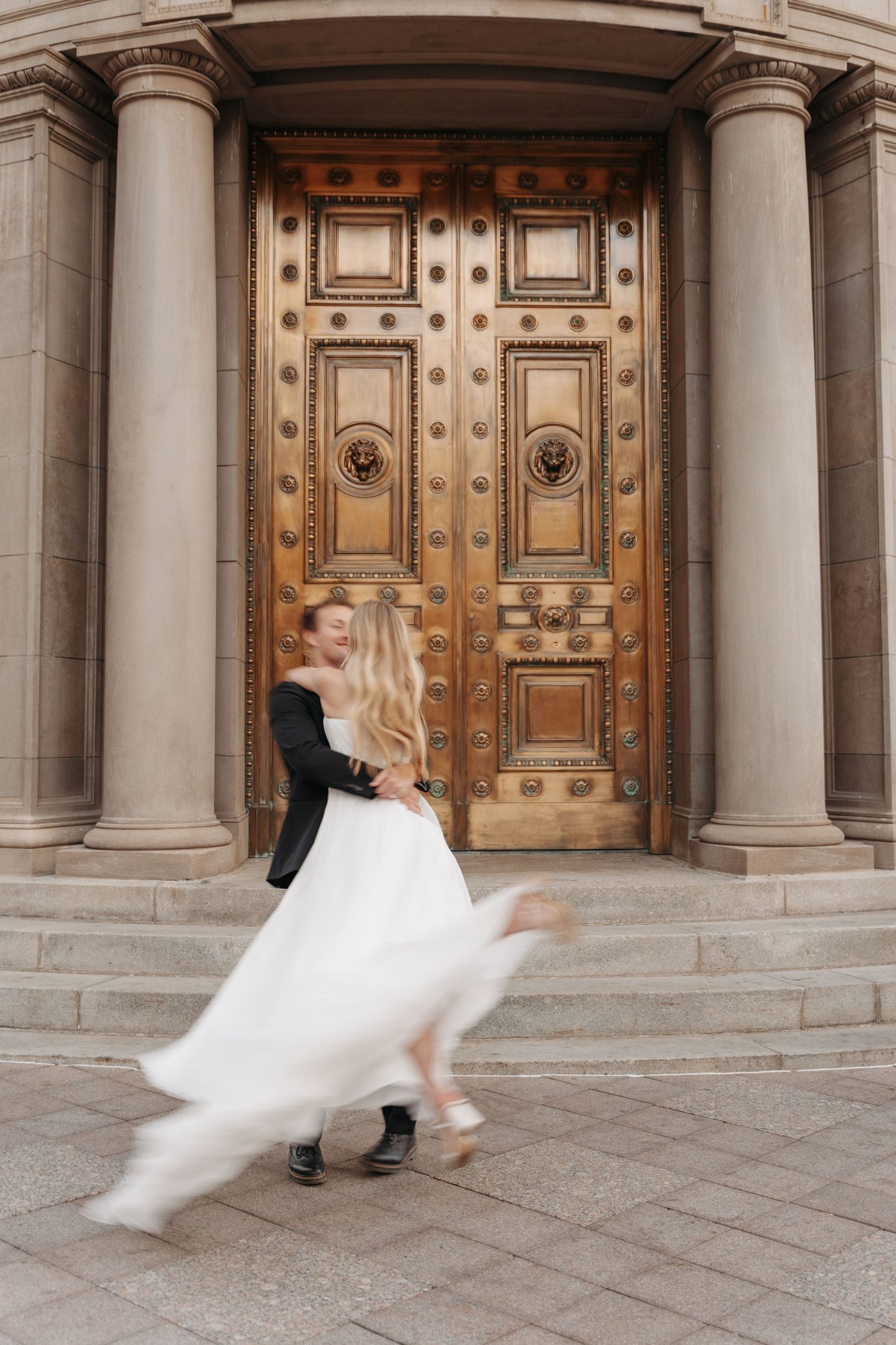 A flowing white wedding dress twirls dramatically against ornate wooden doors and stone columns in a sequence of photos.