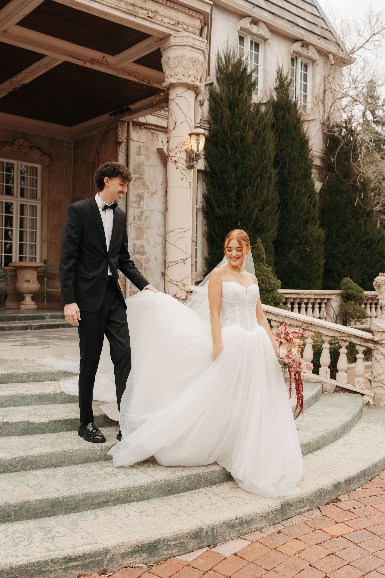 Series of romantic moments as couple walks down ornate mansion steps in formal wedding attire.