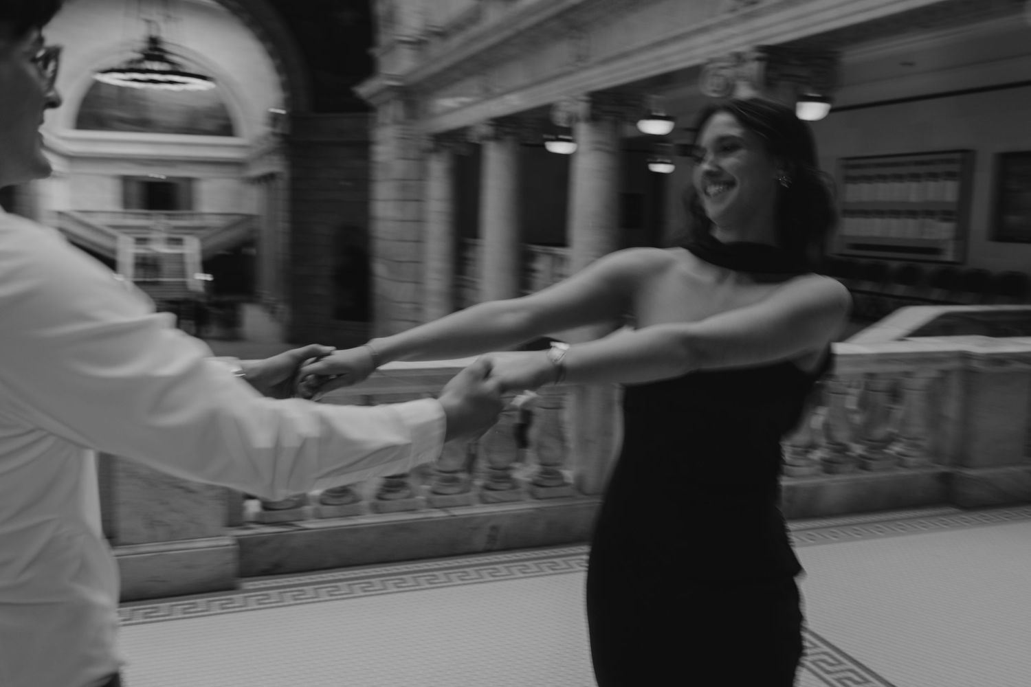 Two people dancing together in an elegant ballroom dance pose with graceful form and movement.