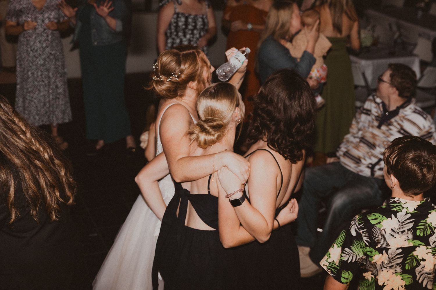 Bride and friends dance at wedding reception in Colorado