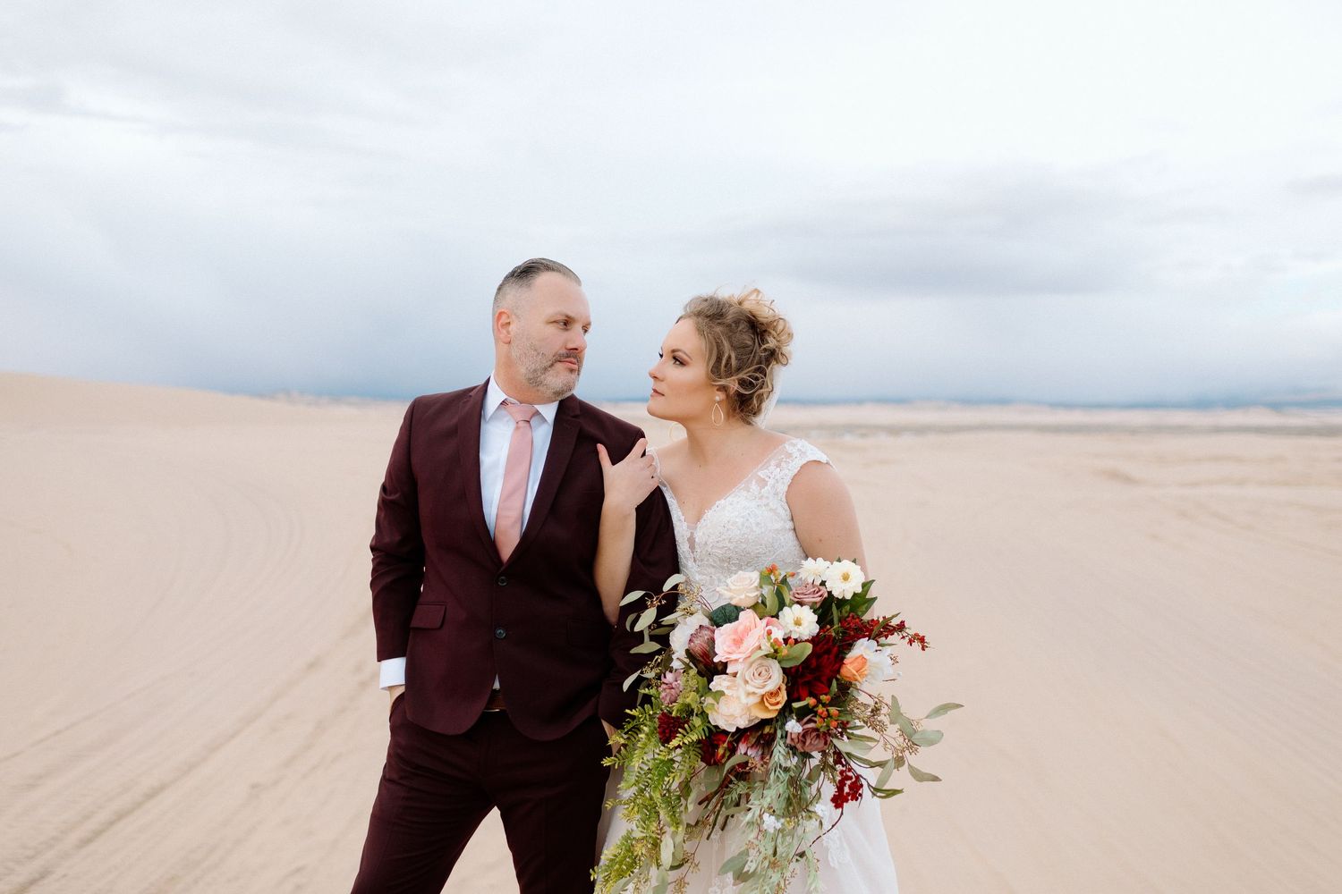 Wedding Couple getting bridal photos done at the Little Sahara Sand dunes in Utah