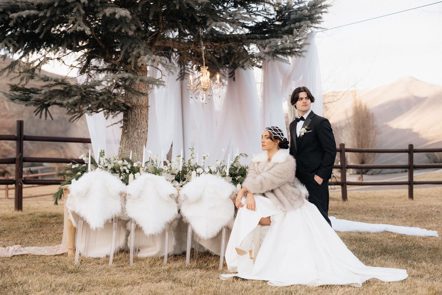 Wedding ceremony setup in a rustic outdoor setting with white draping and mountain views in Utah.