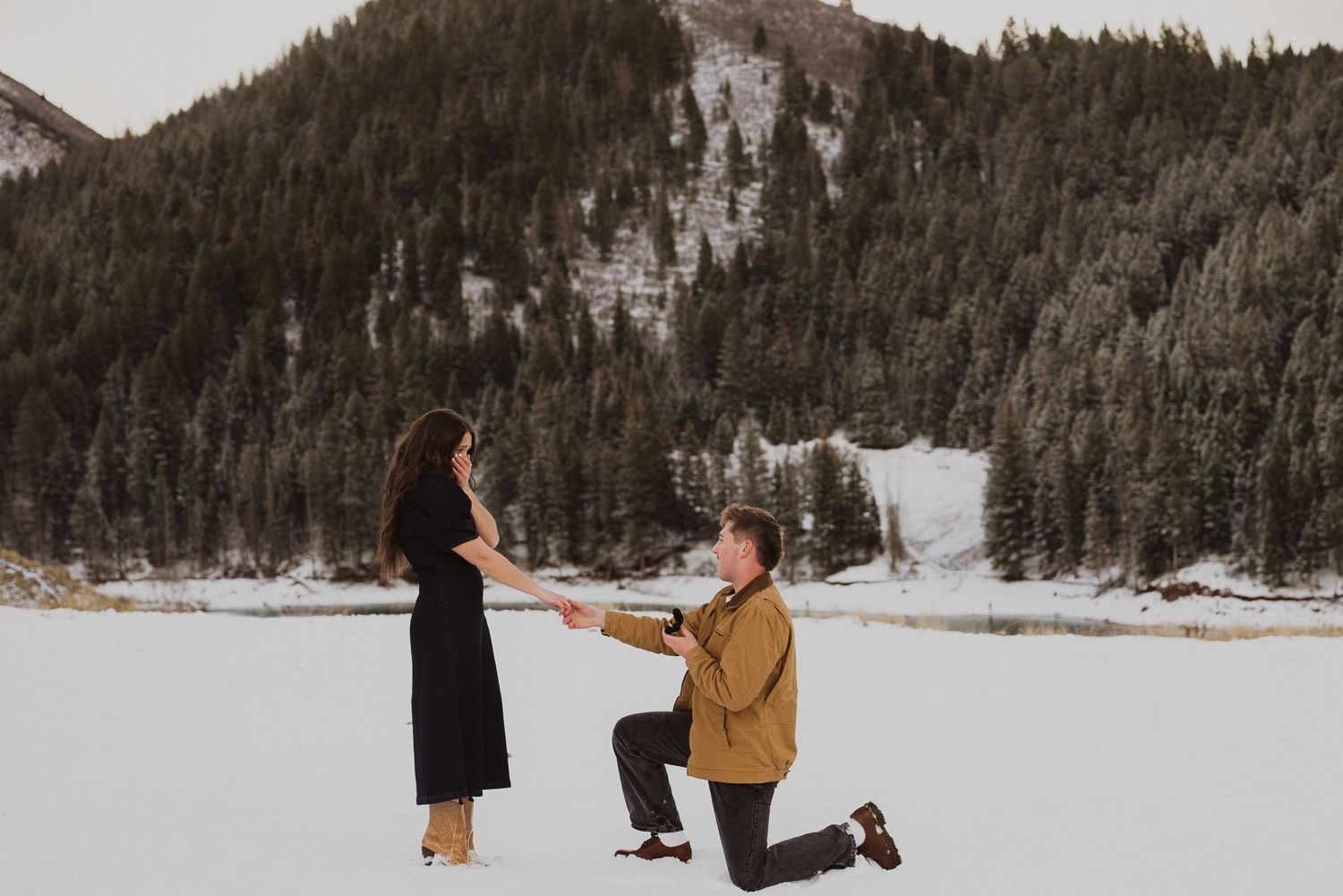 A romantic Utah proposal moment captured in a snow-covered mountain setting.