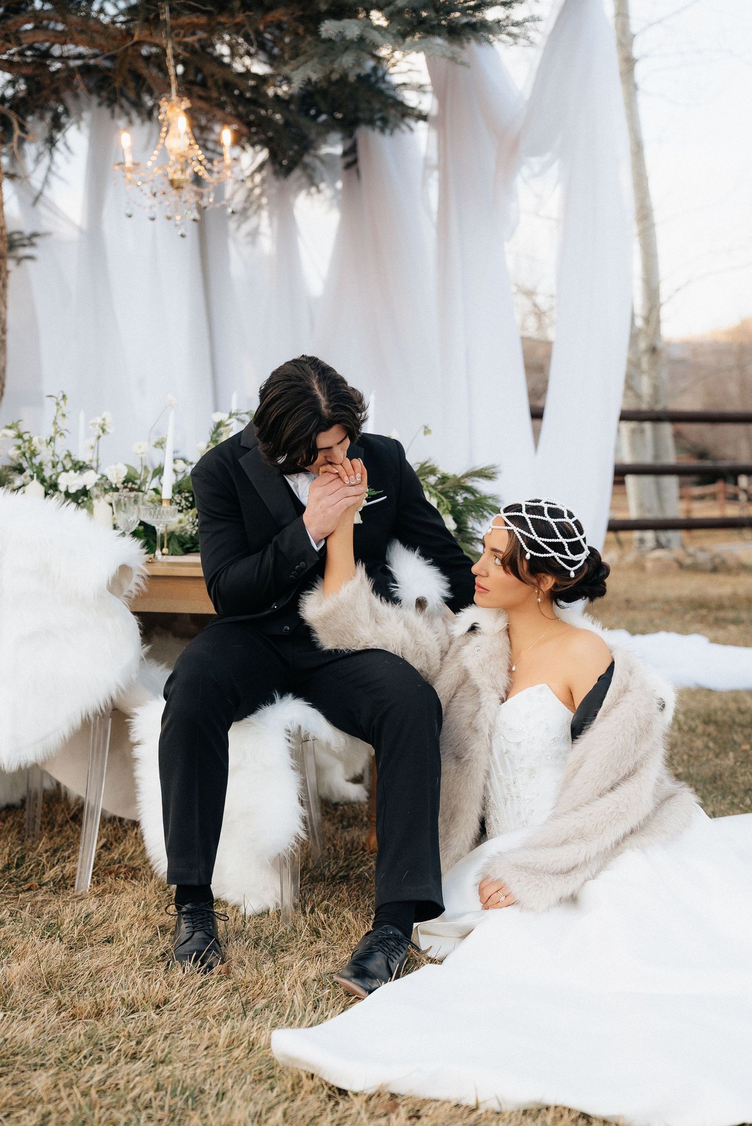 Romantic wedding couple shares intimate moments on a blanket during an outdoor winter photoshoot in Utah.