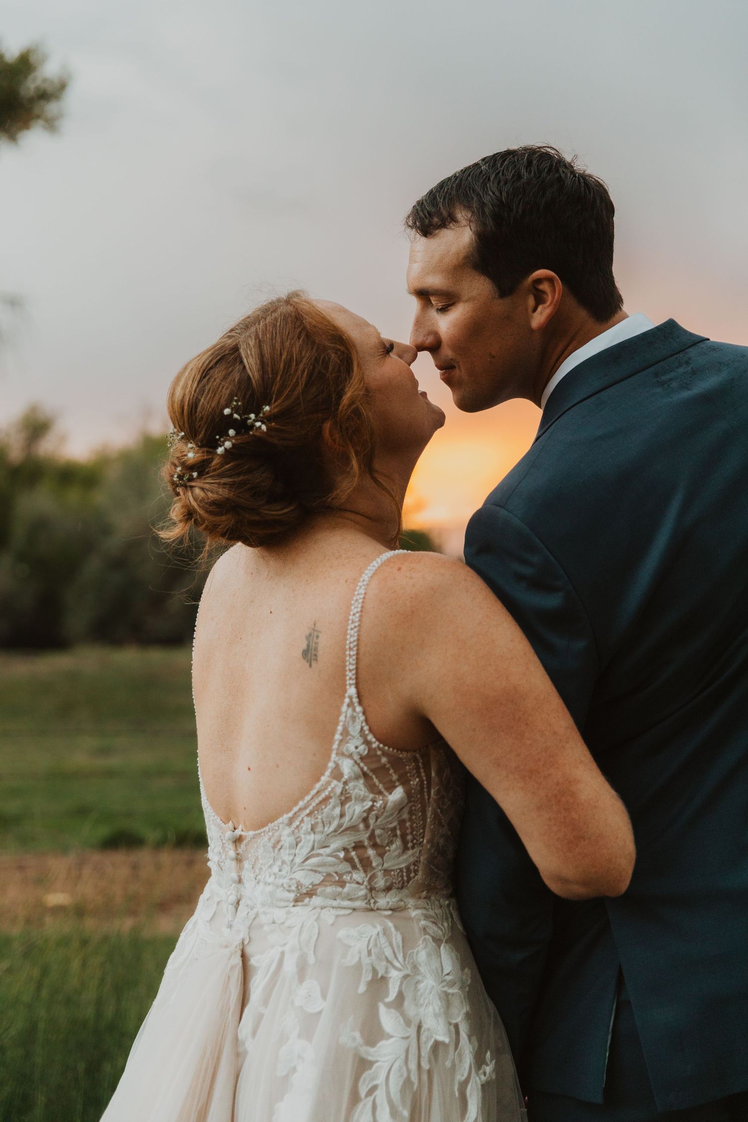 Intimate wedding portraits captured during golden hour showing intricate lace dress details colorado