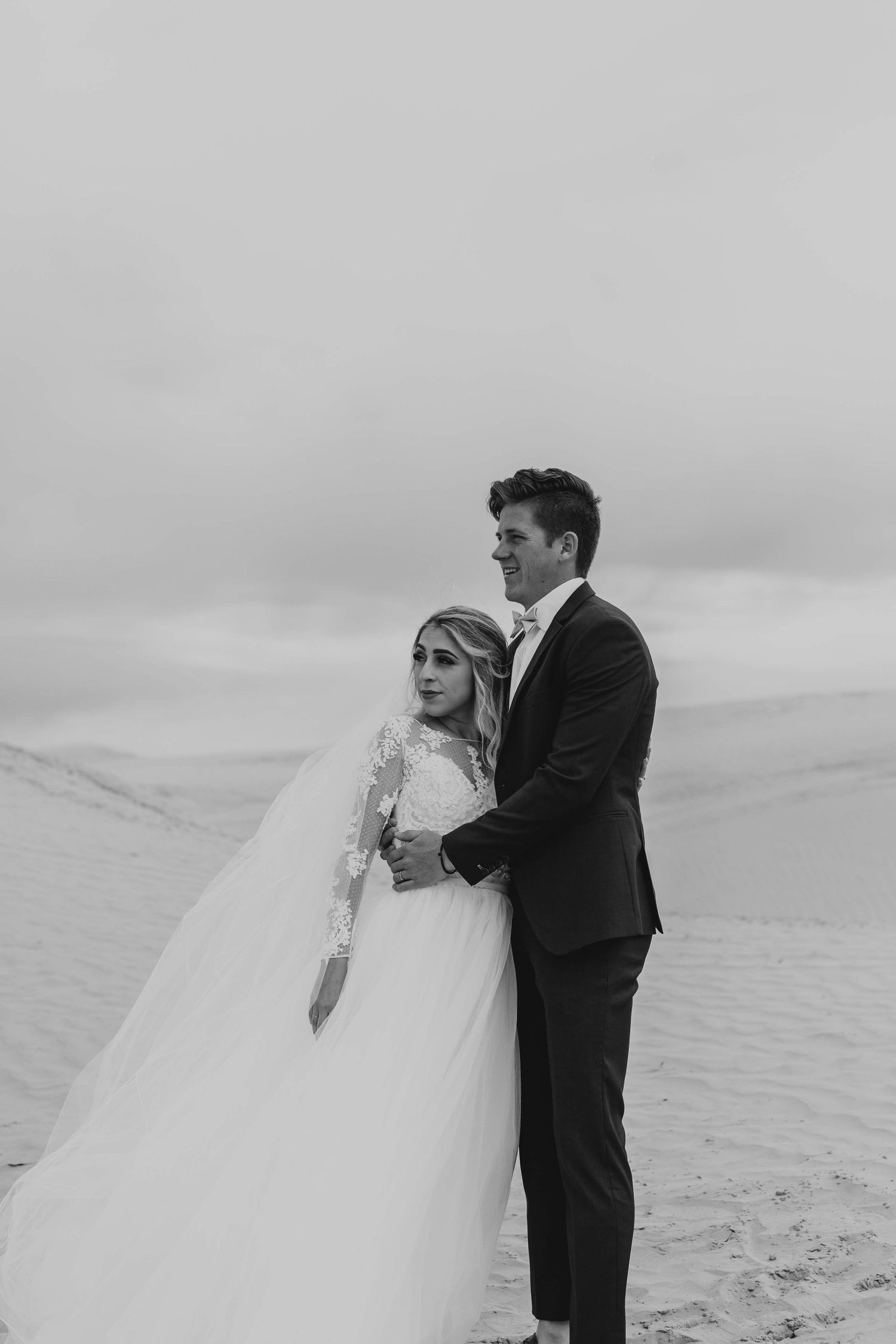 Wedding Couple getting bridal photos done at the Little Sahara Sand dunes in Utah
