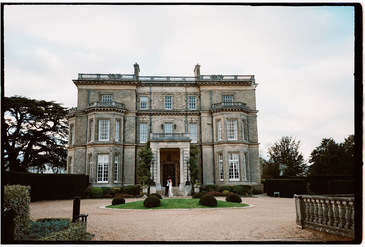 Elegant stone mansion with classical architecture and columns photographed from multiple angles.