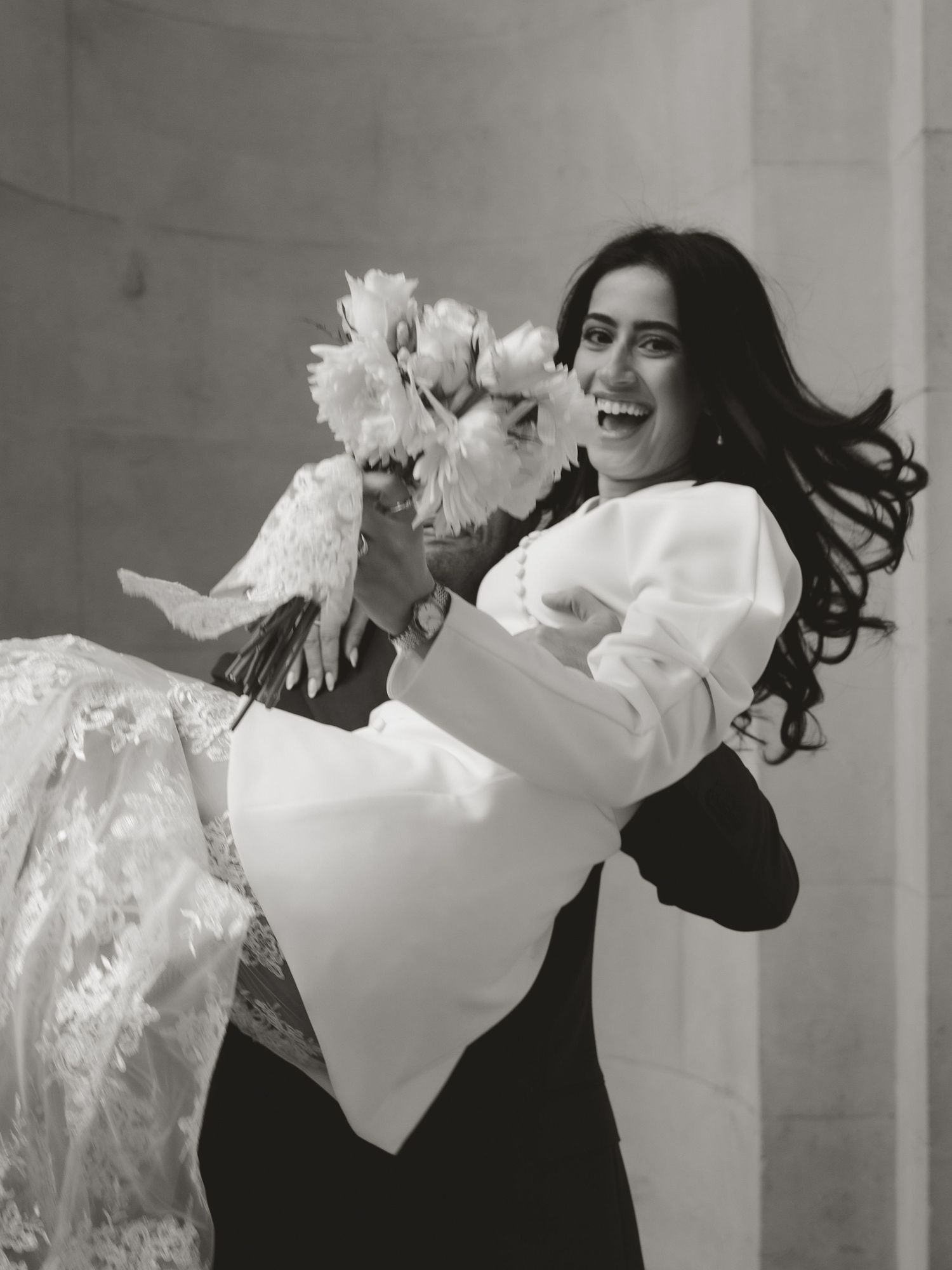 Dynamic sequence of joyful spinning movements in white wedding attire against classical architecture.