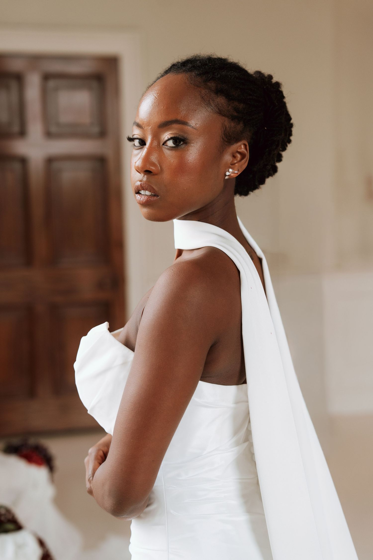 Elegant white wedding gown with dramatic details.