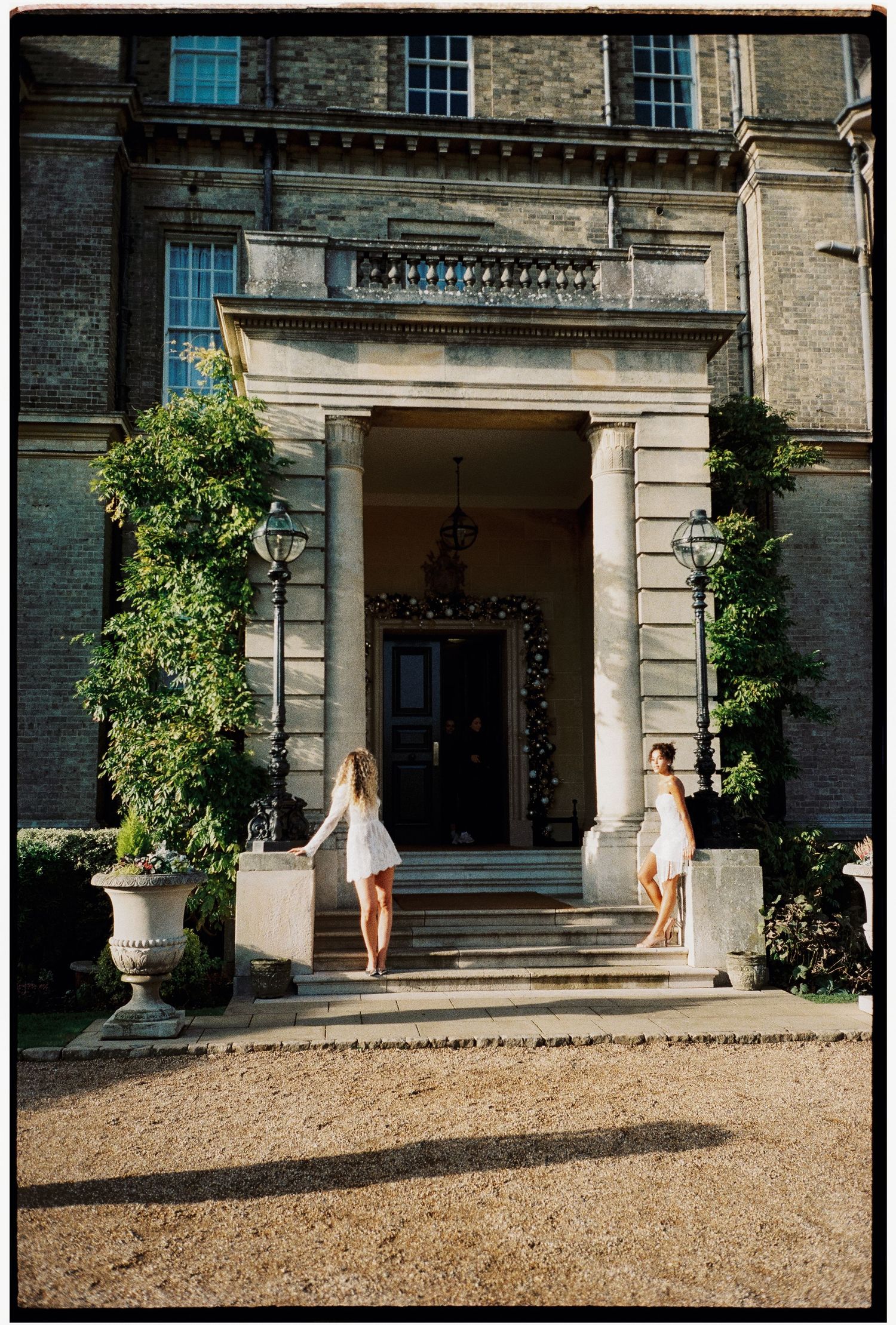 Sequence of bridal poses at stone building entrance with gravel path.