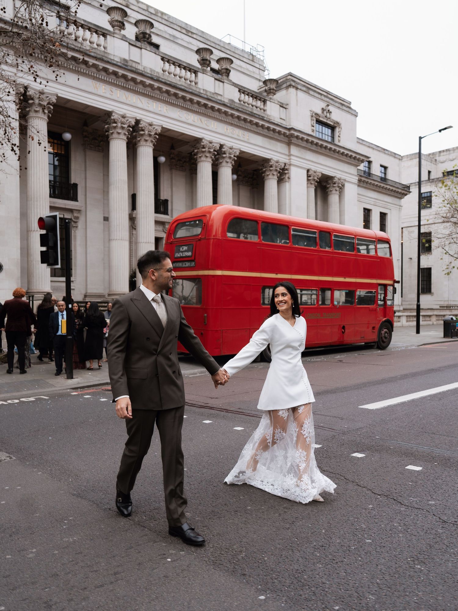 Wedding photo sequence on London street with iconic red double-decker bus in background.