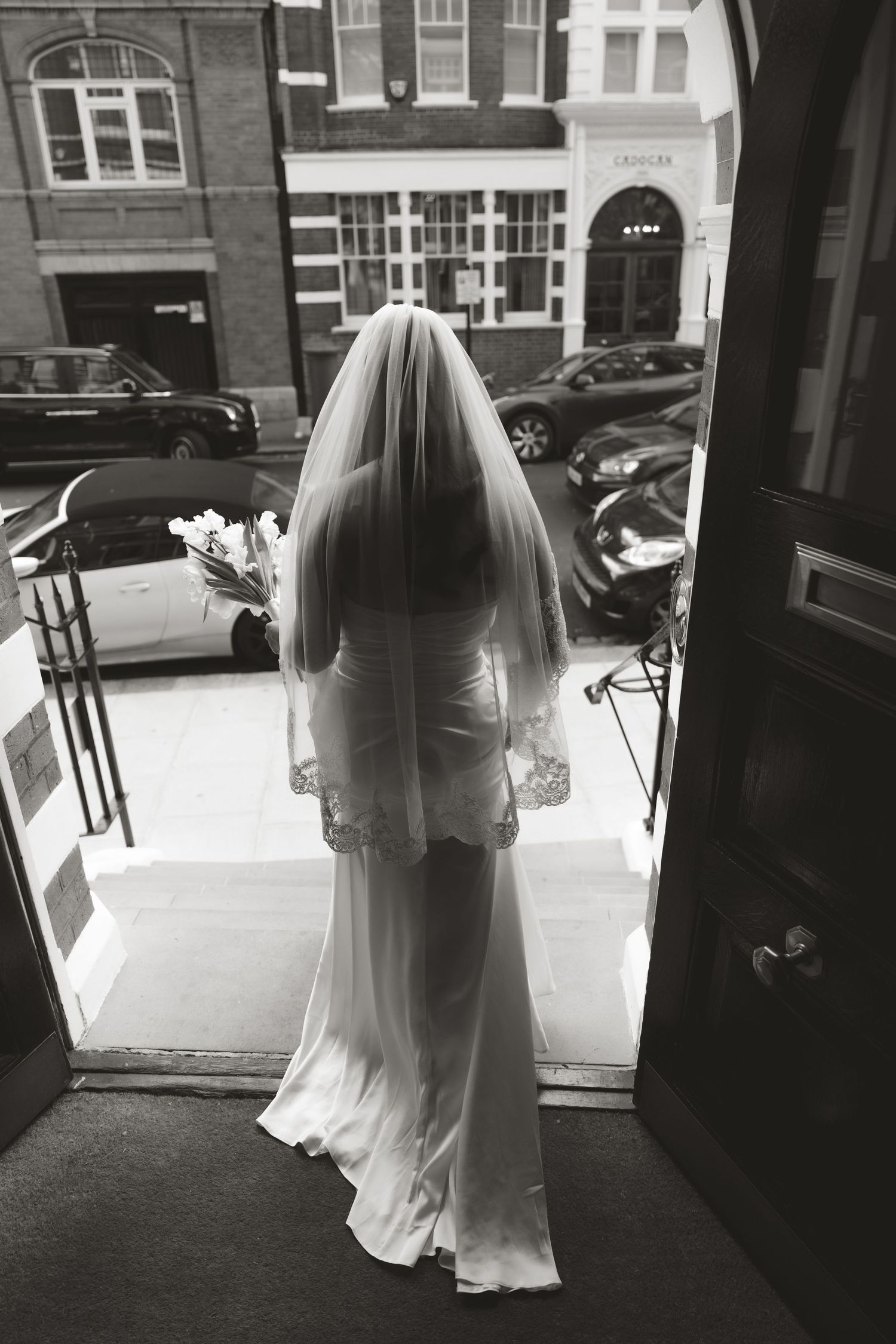 A series of black and white photographs showing a bride in a flowing white dress and veil entering through doorways.