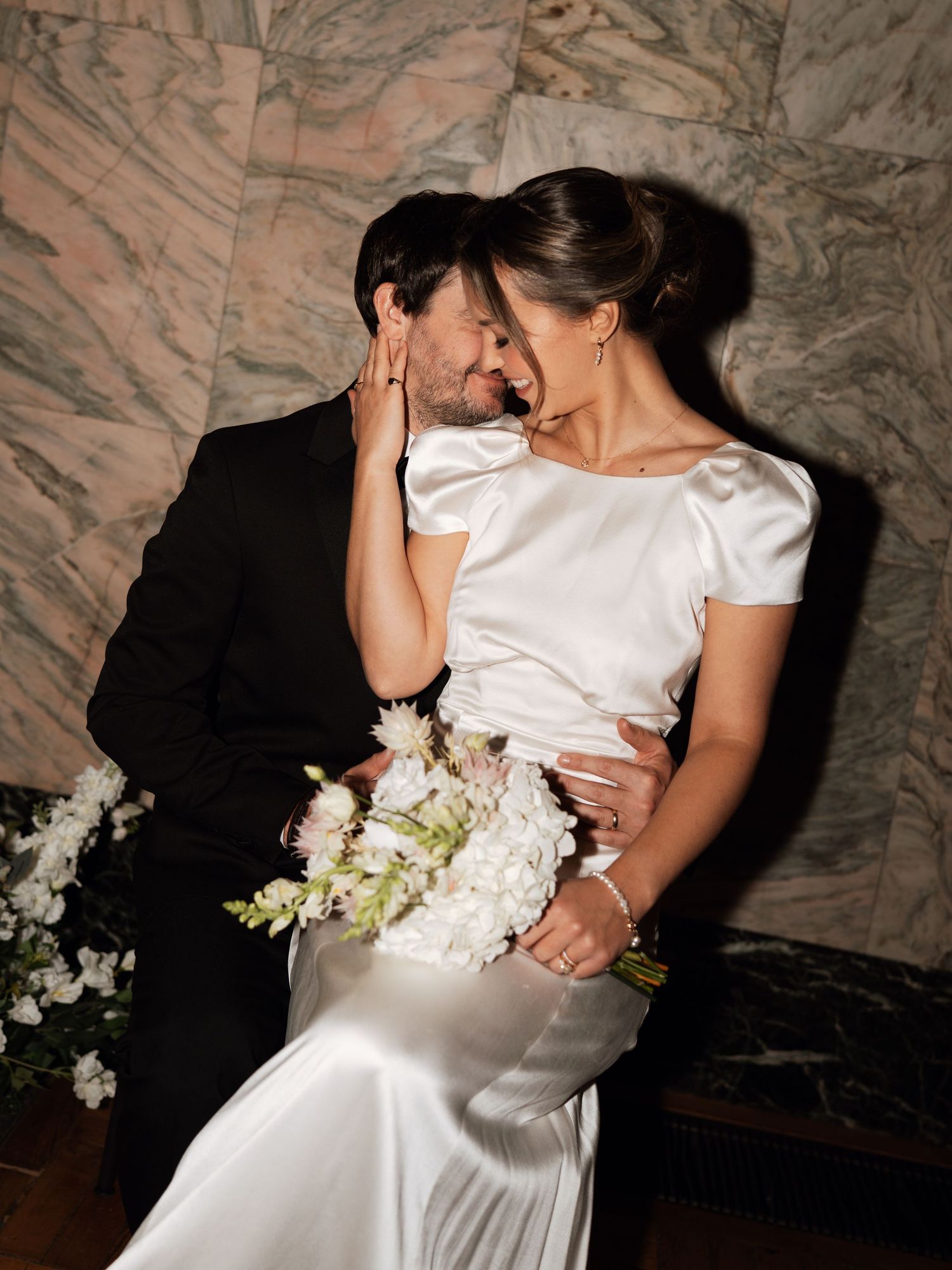 A romantic wedding moment captured in a series of intimate dance poses with white floral bouquet.