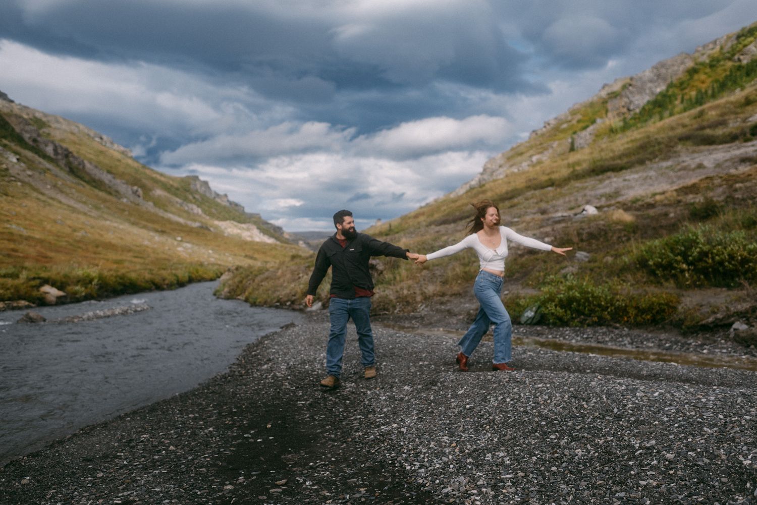Couple at Denali National Park in Alaska during October, surrounded by open mountain landscape.