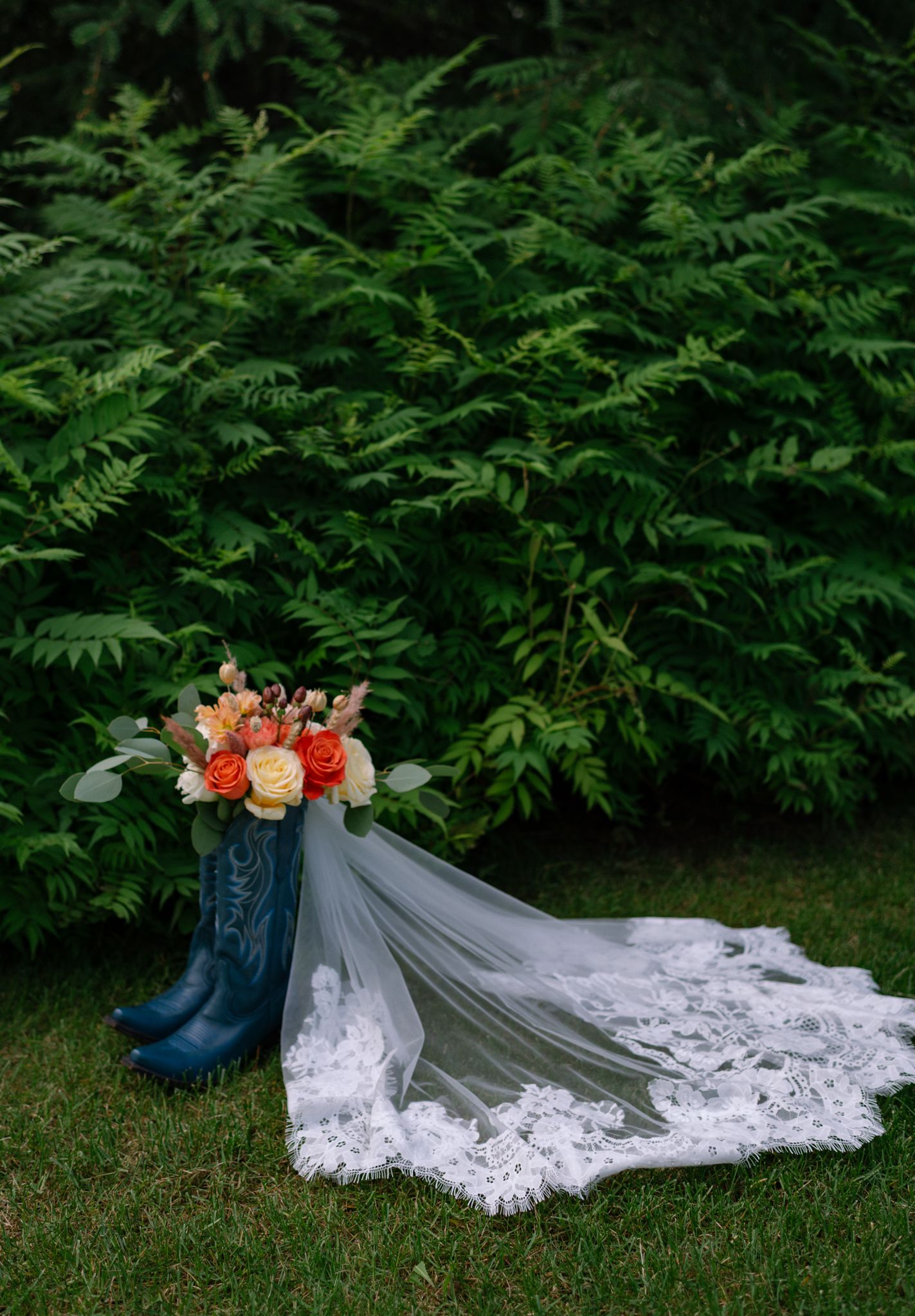 Bridal boots and wedding flowers photographed at a Fairbanks Alaska wedding.