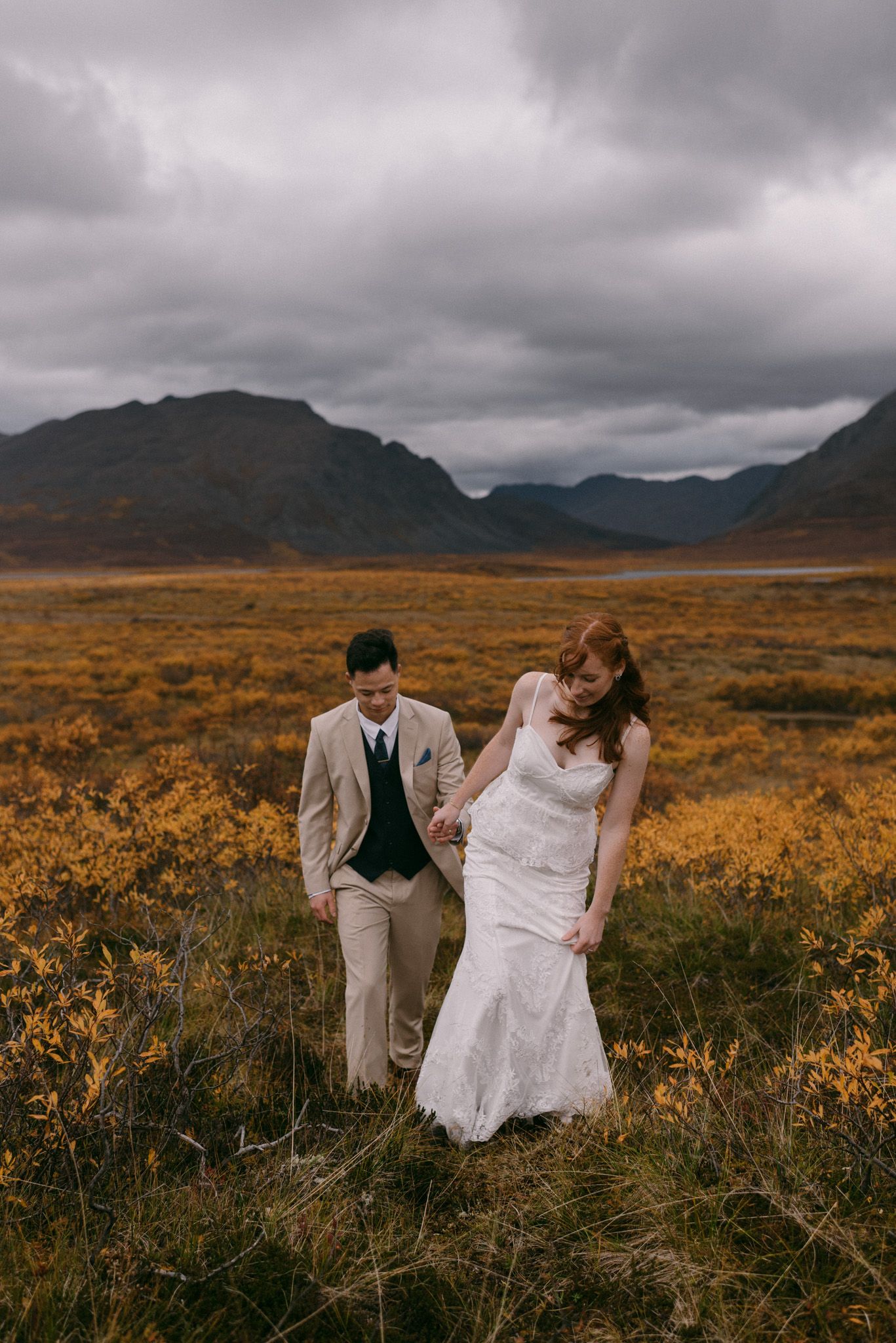 Eloping couple in Denali National Park, Alaska sharing an intimate moment during their elopement
