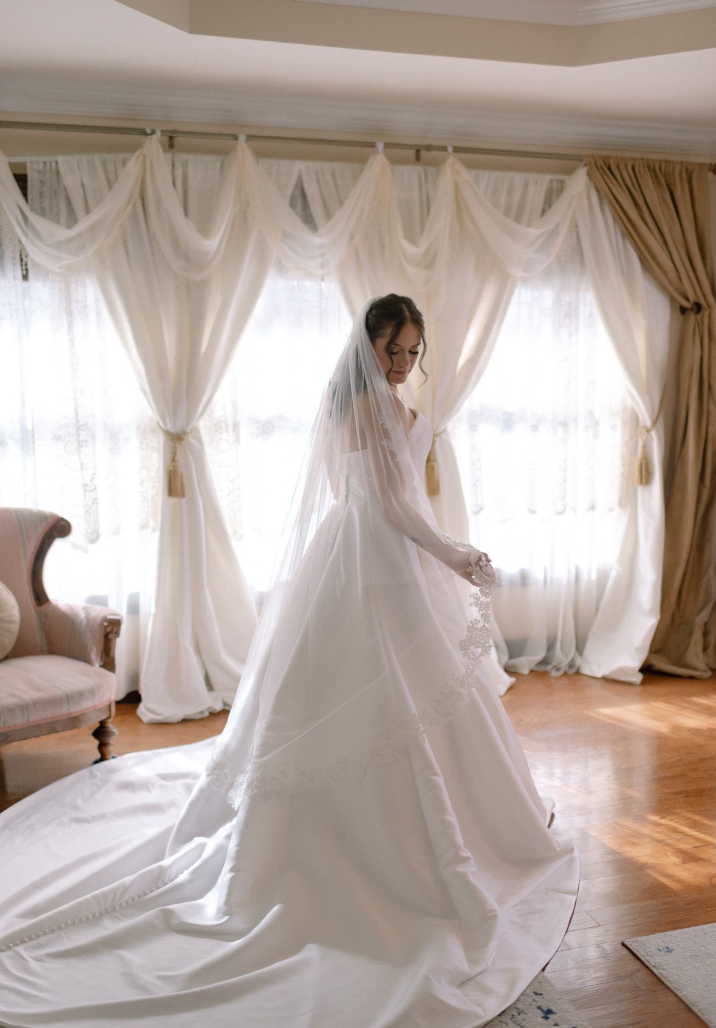 Bridal portrait in Fairbanks, Alaska, softly lit by natural window light, creating a warm, ethereal glow.