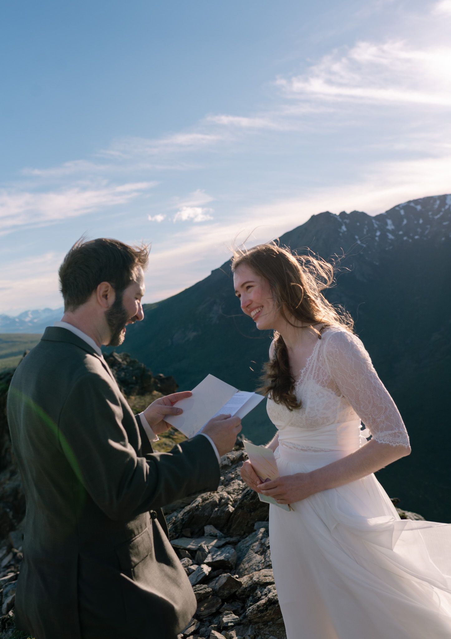Couple exchanging private vows on a mountain peak in Denali National Park, Alaska, surrounded by breathtaking wilderness views.