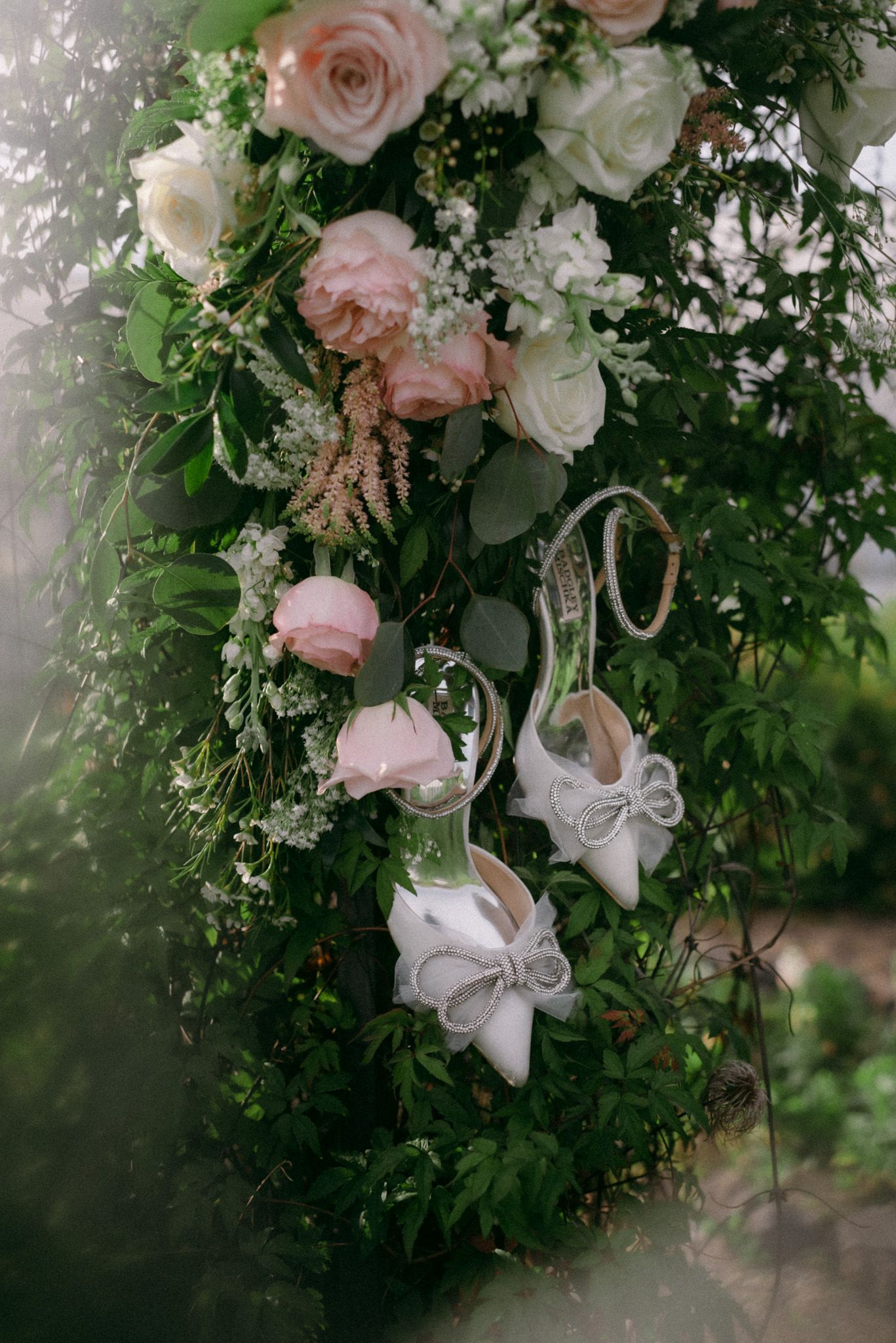 Fairbanks, Alaska wedding photographer capturing bridal details, including bridal shoes hanging from floral vines on a wedding day.
