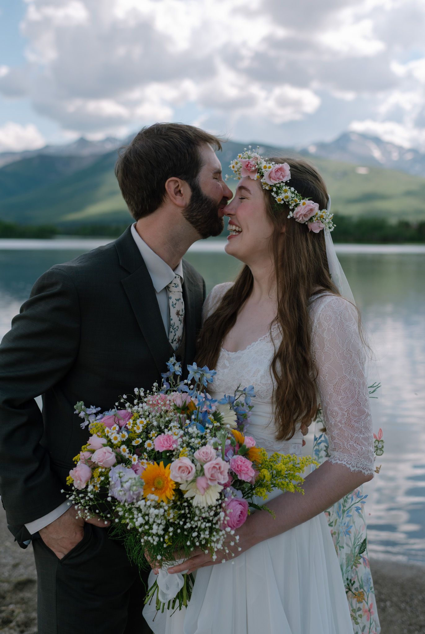 Bride and groom sharing a romantic embrace on their wedding day in Fairbanks, Alaska.