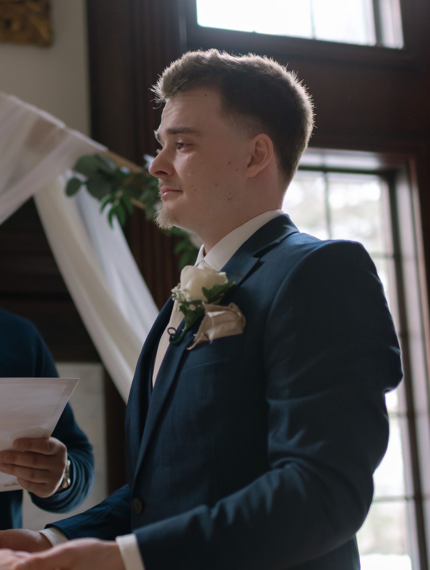 Groom tearing up in front of his bride at their wedding ceremony, capturing a heartfelt moment in Fairbanks, Alaska.