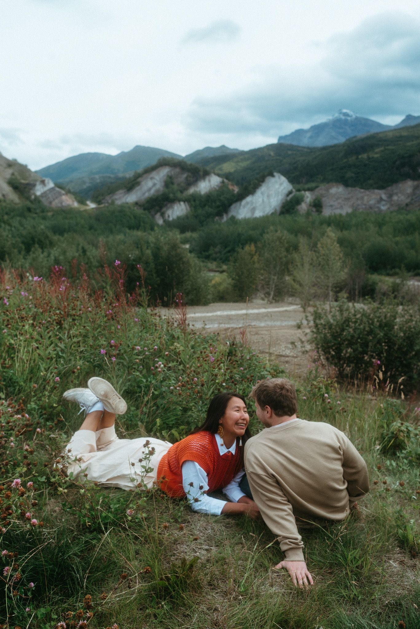 Couple sharing an intimate summer moment in Denali National Park, Alaska, surrounded by mountain views.