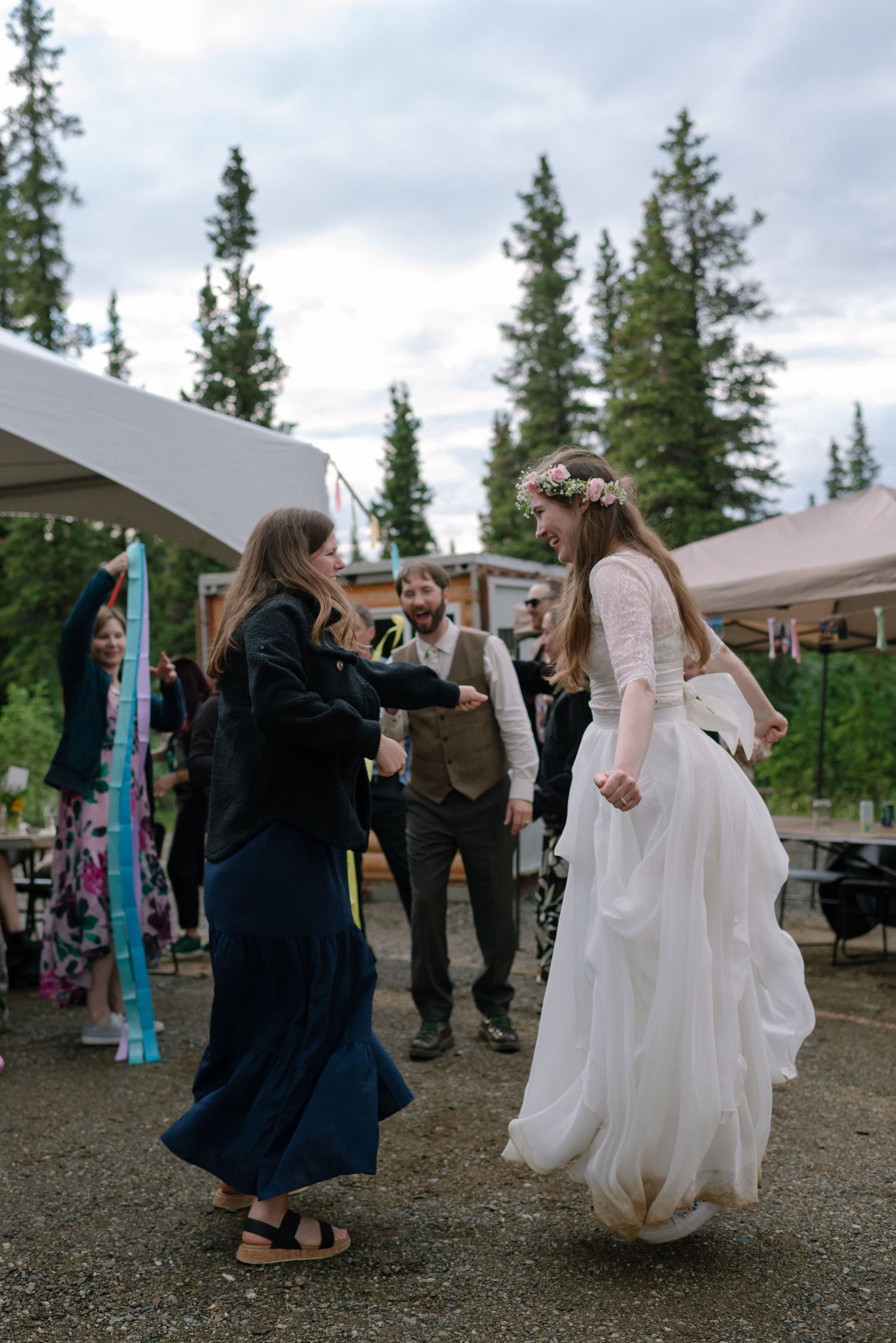 Bride and groom celebrating with loved ones on the dance floor at their Denali Alaska wedding.