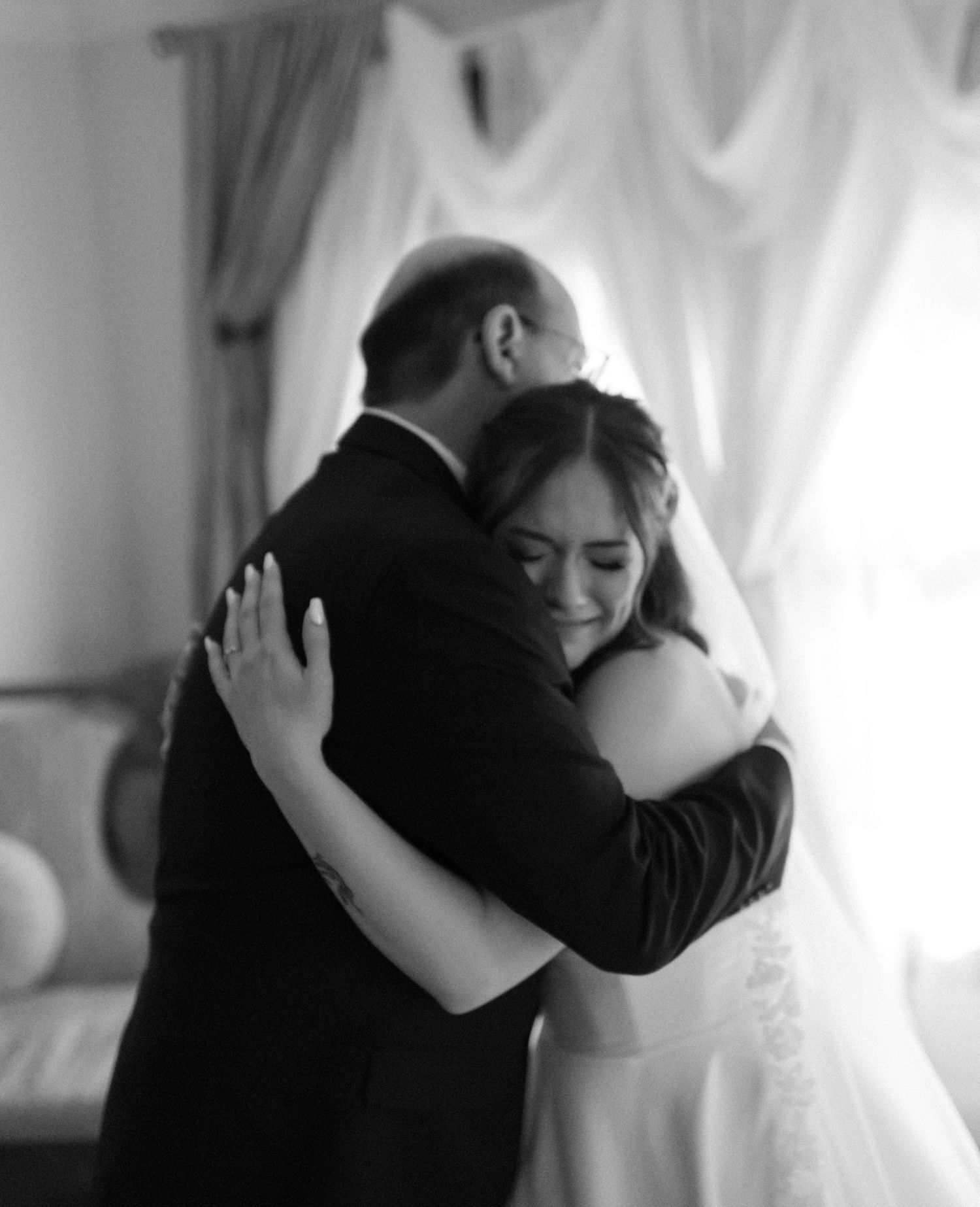Bride sharing her first look with her dad at Huffman Manor in Fairbanks, Alaska, a touching moment full of happy tears.