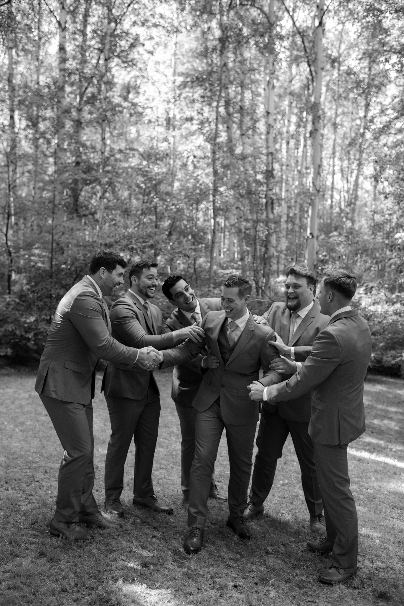 Wedding day celebration with groom and groomsmen cheering at Huffman Manor in Fairbanks, Alaska.