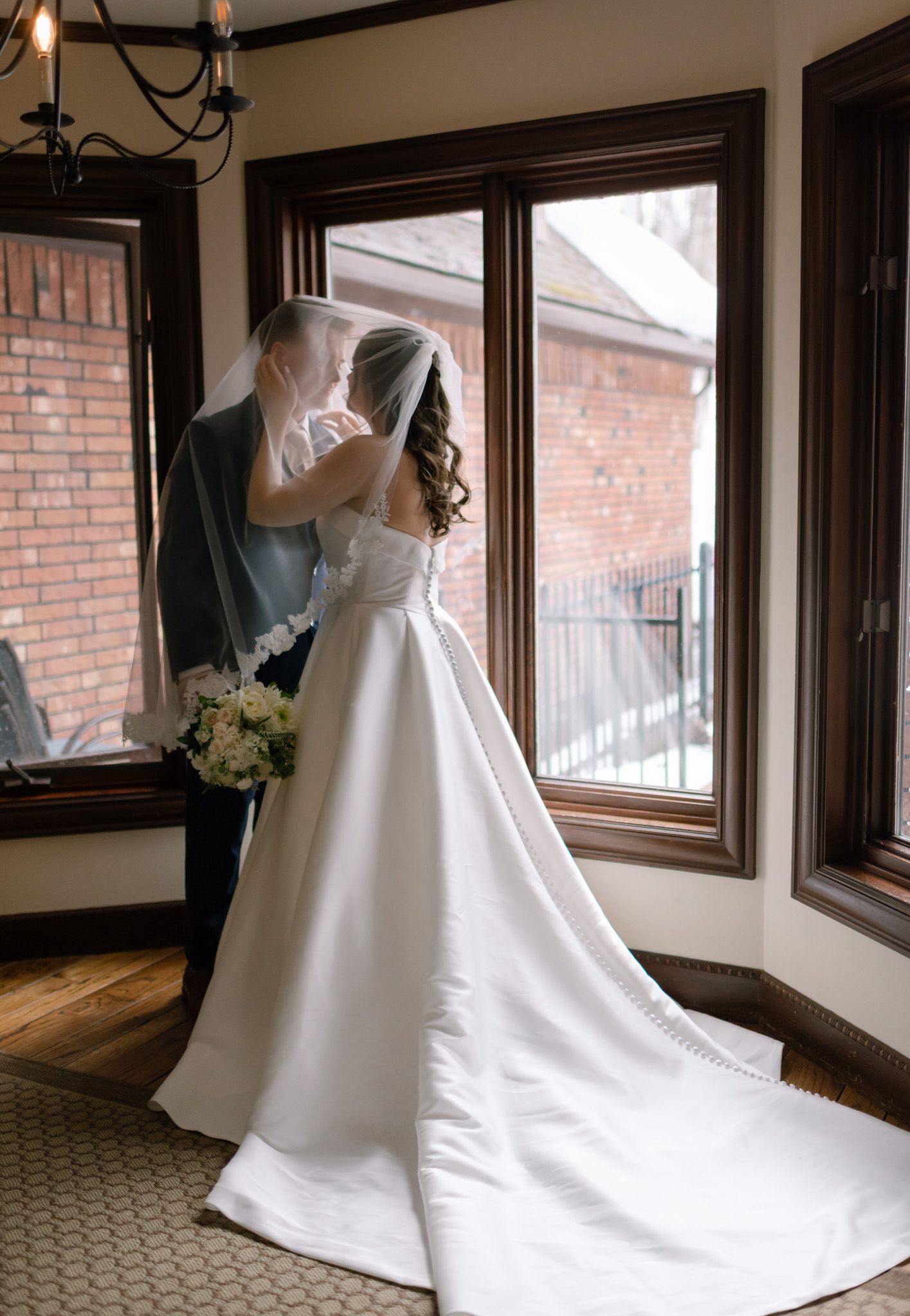 Romantic wedding moment between bride and groom during their wedding at Huffman Manor in Fairbanks, Alaska