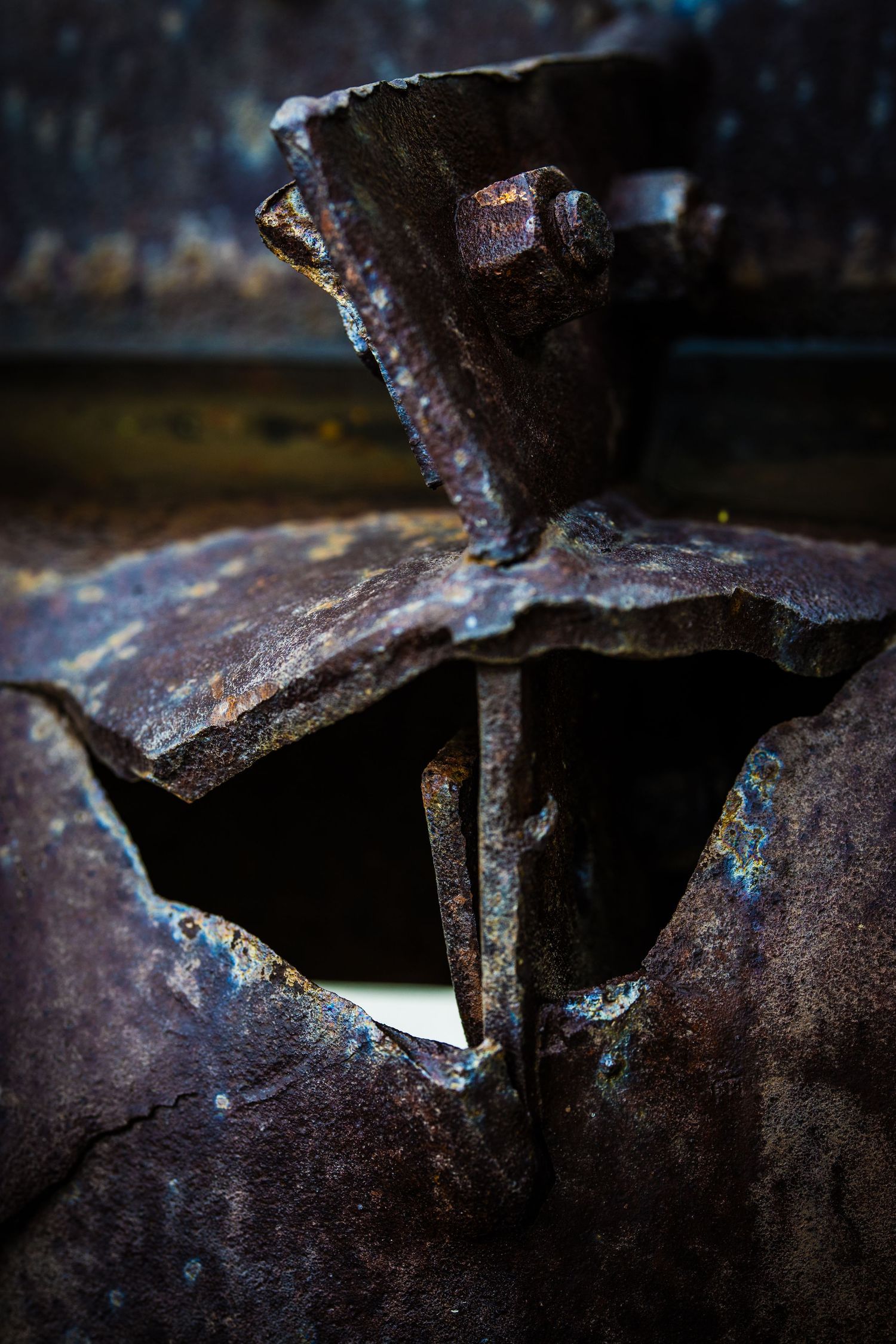 Close-up of heavily rusted and deteriorating metal machinery parts.
