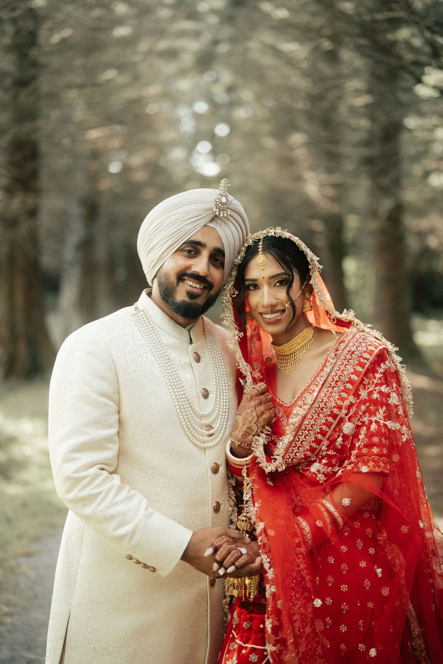 Candid wedding portraits showing laughter and joy between newlyweds in traditional attire.