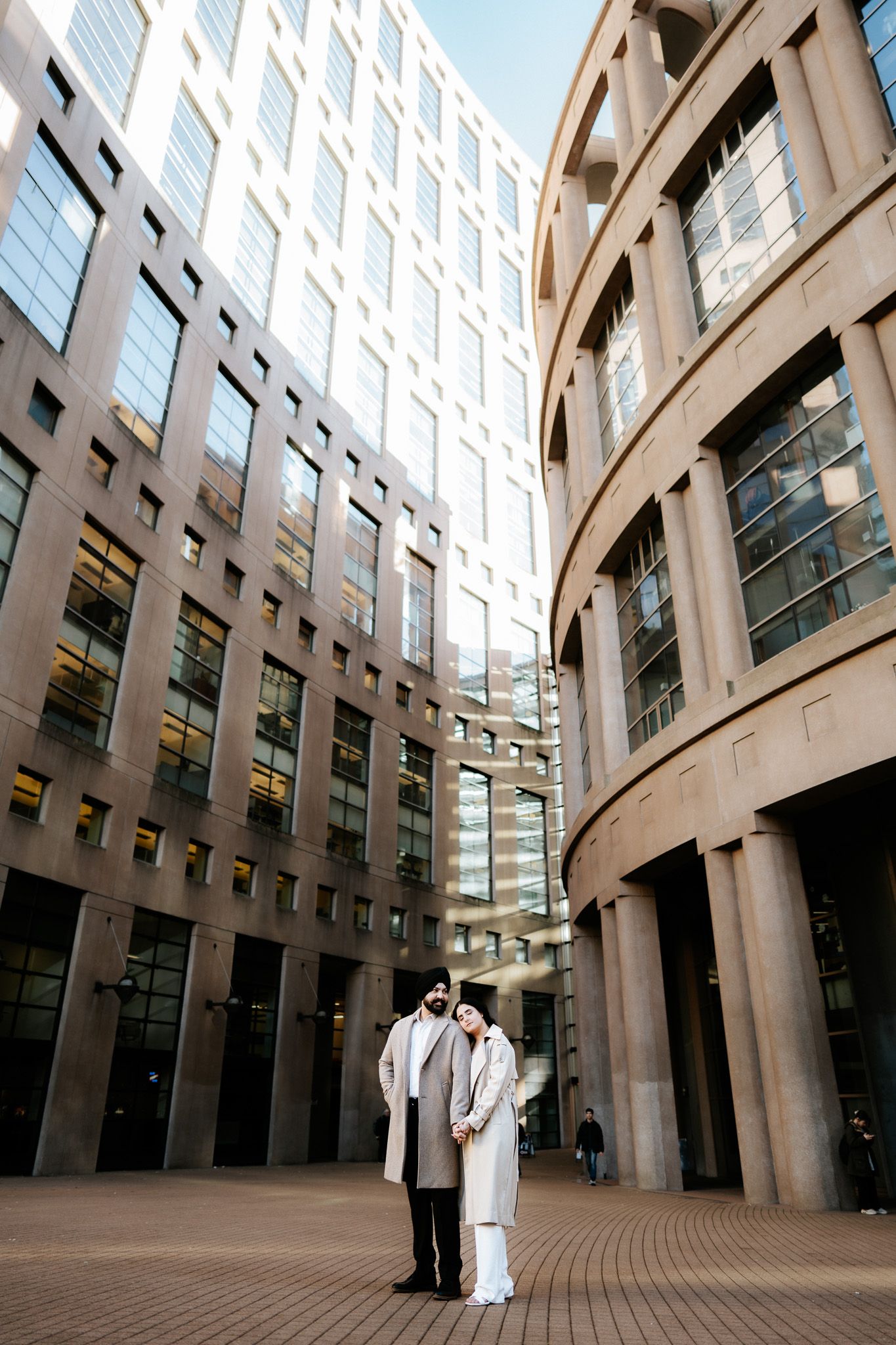 Modern architectural interior with curved columns and glass windows in a contemporary office building atrium.