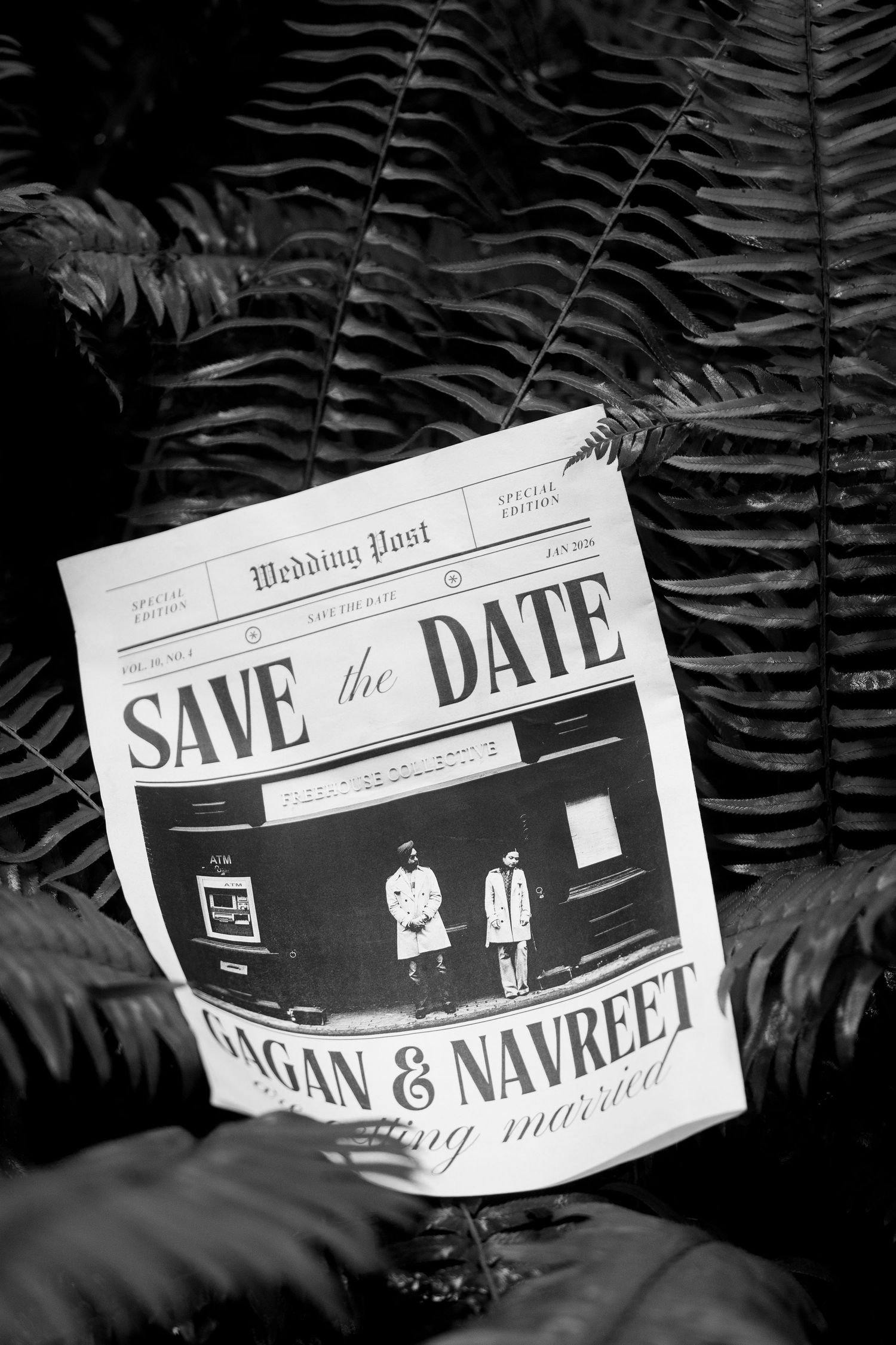 Black and white newspaper-style save the date announcement displayed against fern leaves.